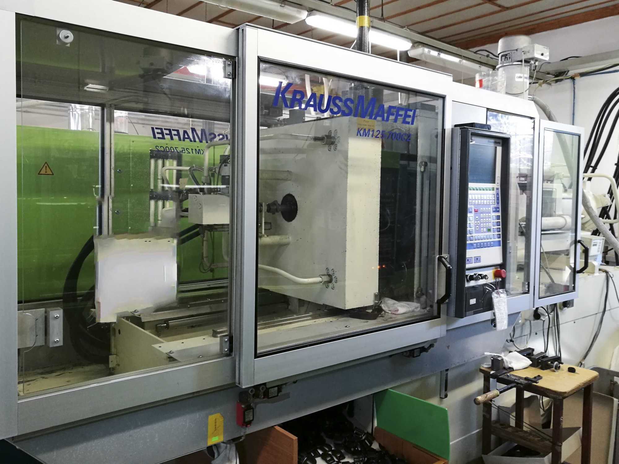 Left view of Krauss Maffei 125-700 C2 Machine