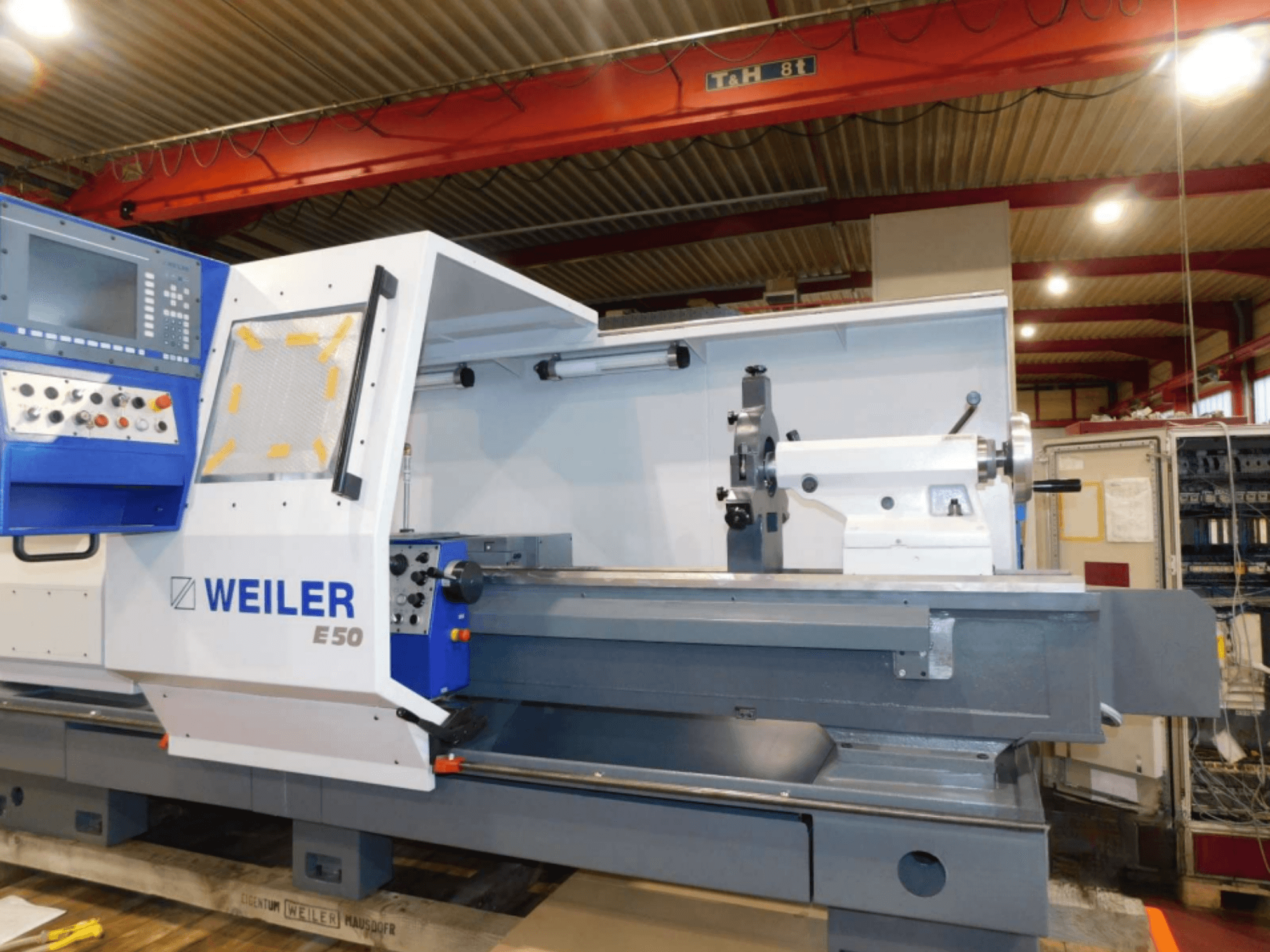 Weiler E50 horizontal turning machine, front view, features control panel, spindle, and precision bed with accessories.
