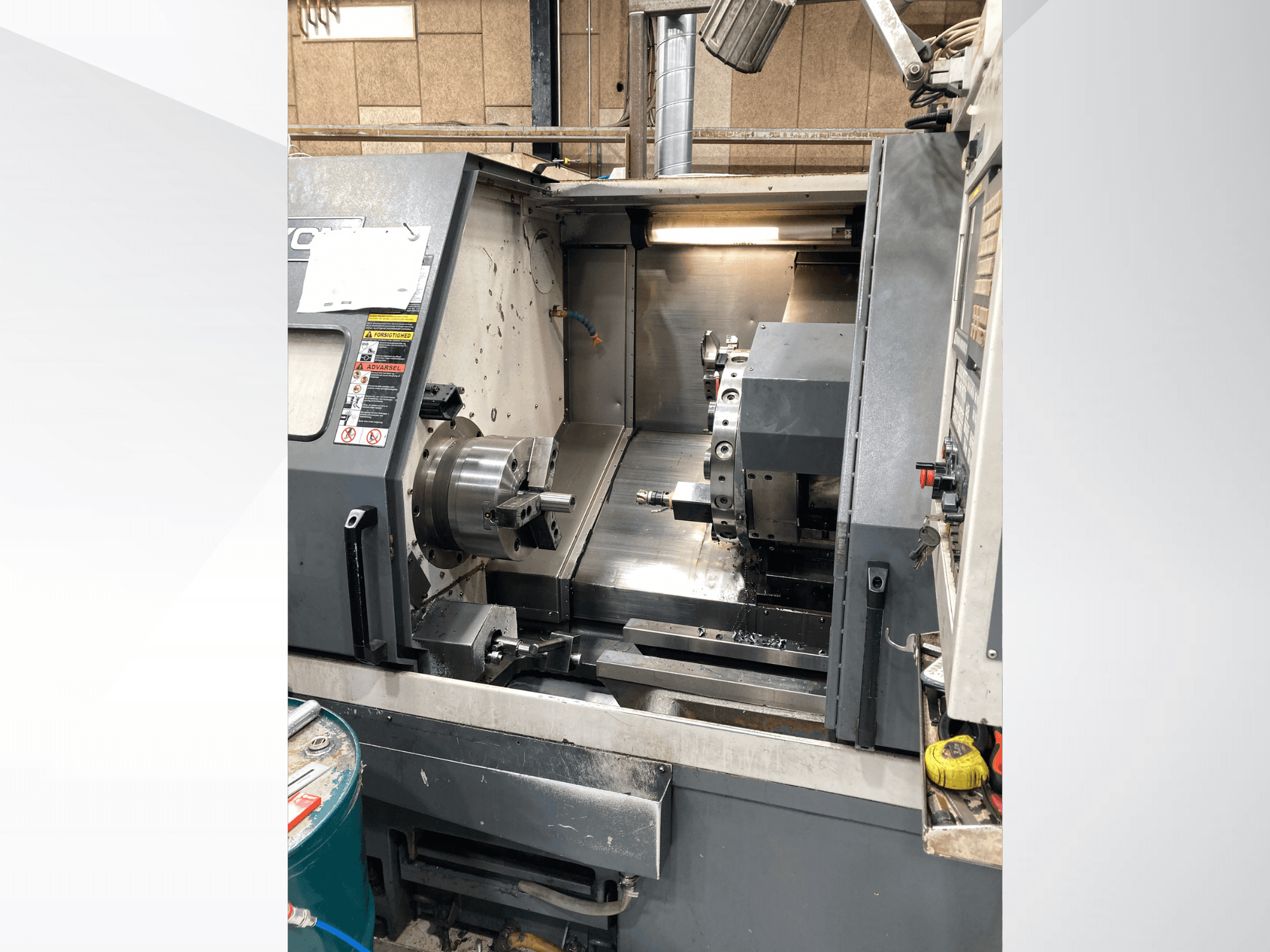 Horizontal turning machine YCM GT-300LMB, front view, showcasing the control panel and spinning chuck with tooling setup.