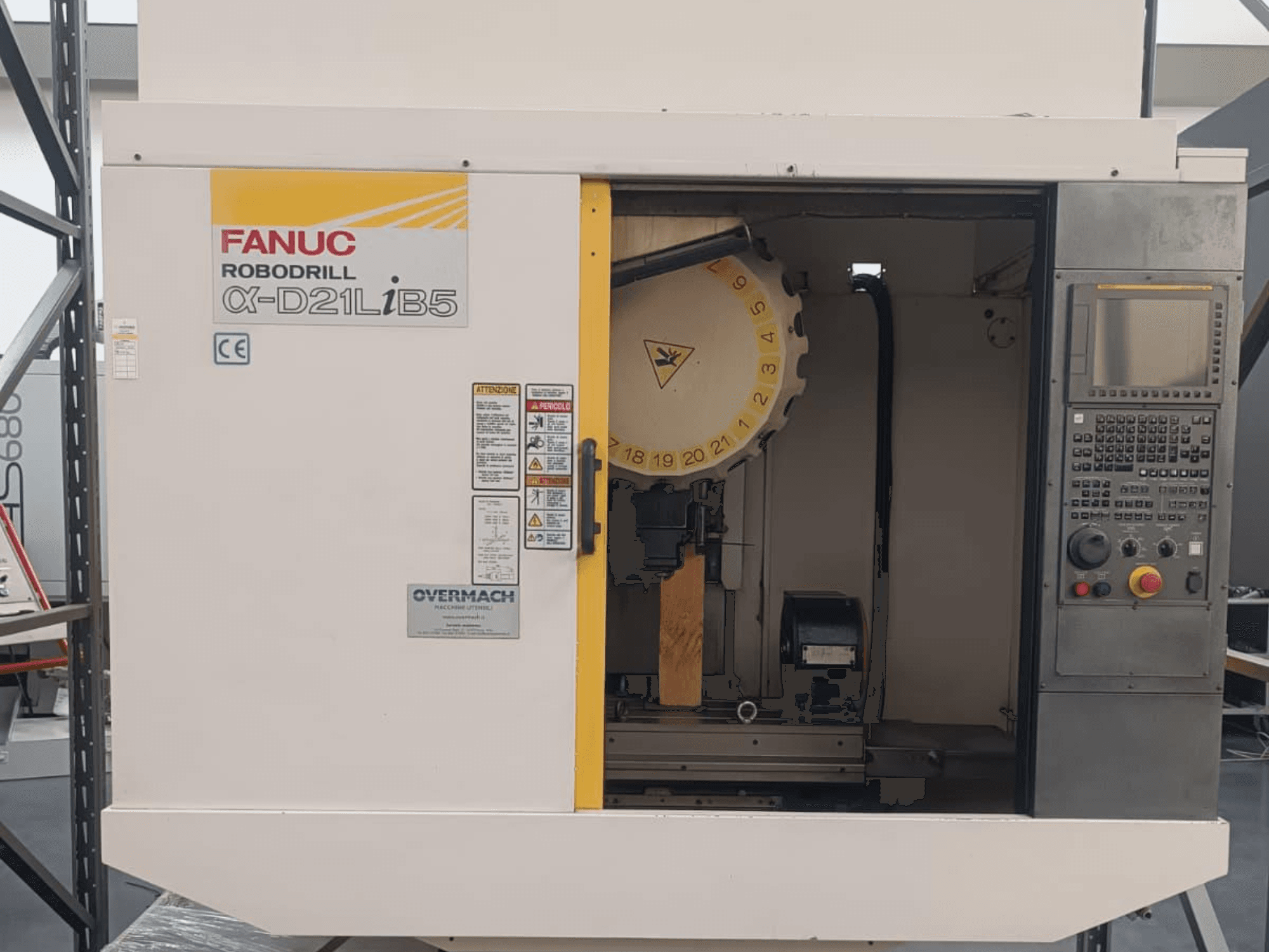 FANUC Robodrill α-D21LiB5, front view; CNC machine with tool holder, control panel, and safety warnings visible.