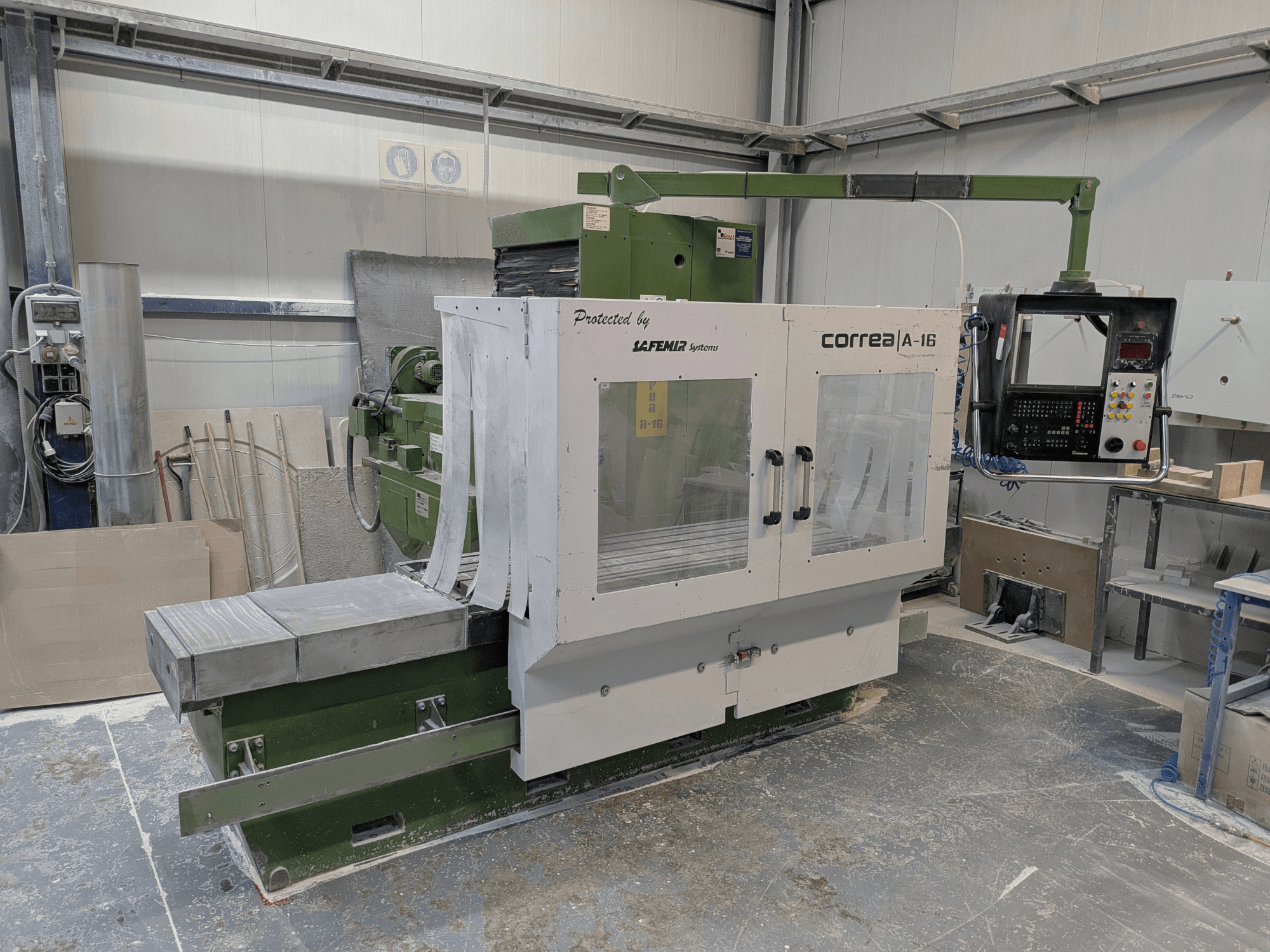 Correa A-16 milling machine in a workshop, front view with control panel and work surface, showcasing industrial design and functionality.