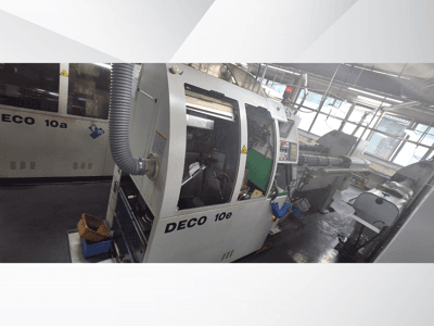 DECO 10e CNC machine in side view, featuring a control panel, green interior, and connected exhaust hose.