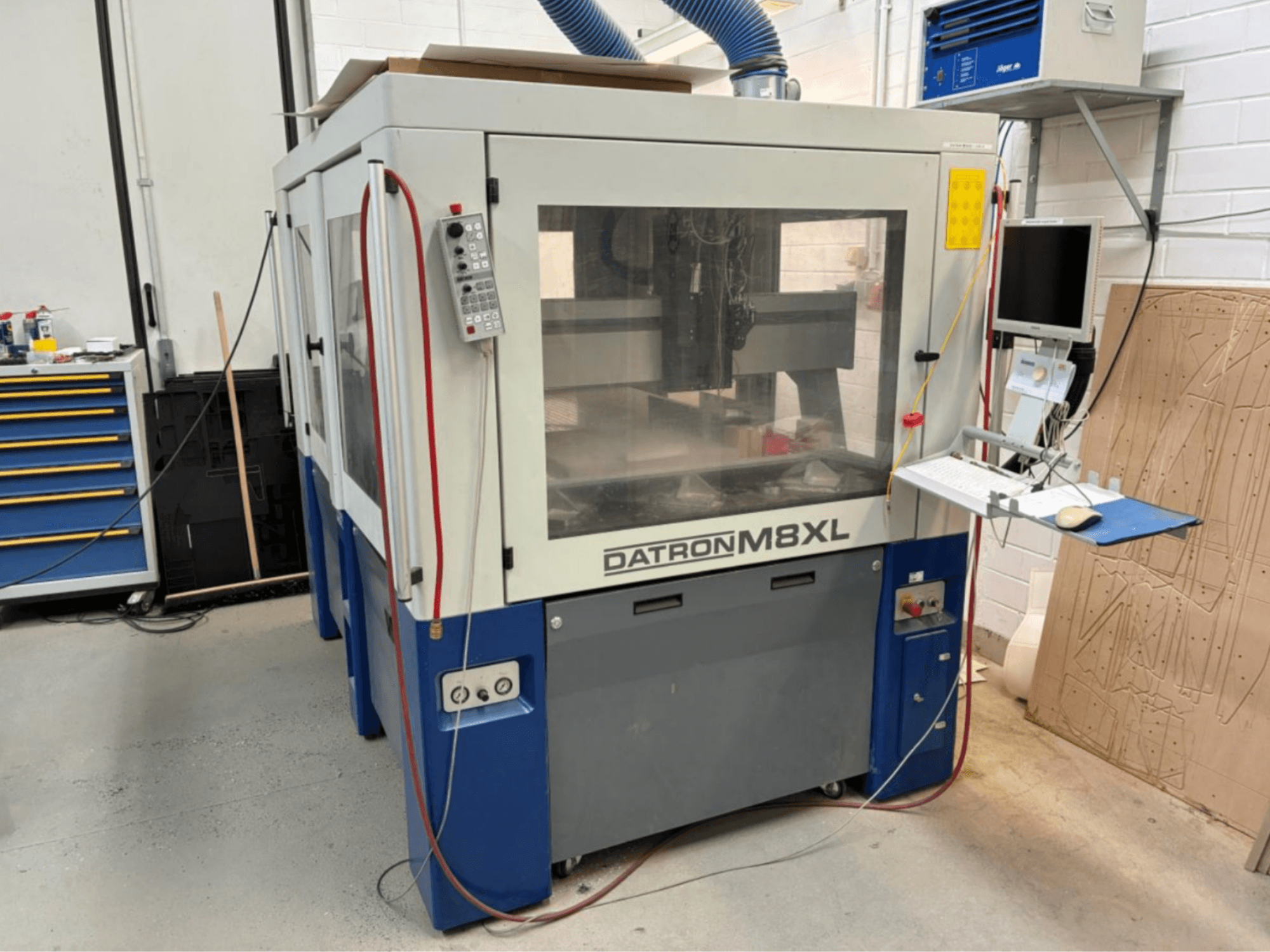 DATRON M8XL CNC machine in a workshop, front view with control panel and monitor mounted beside it.