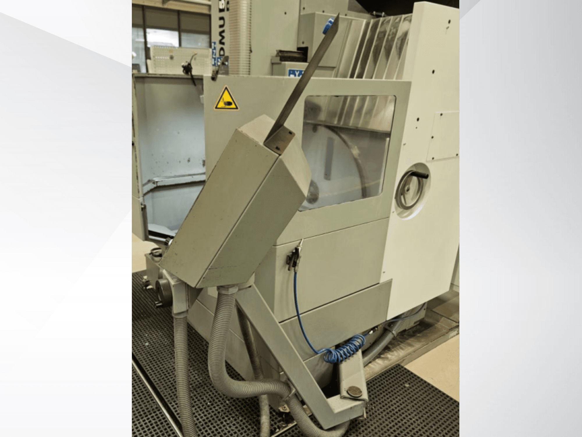 DMU milling machine side view with coolant nozzle and integrated control panel; features safety warning label.