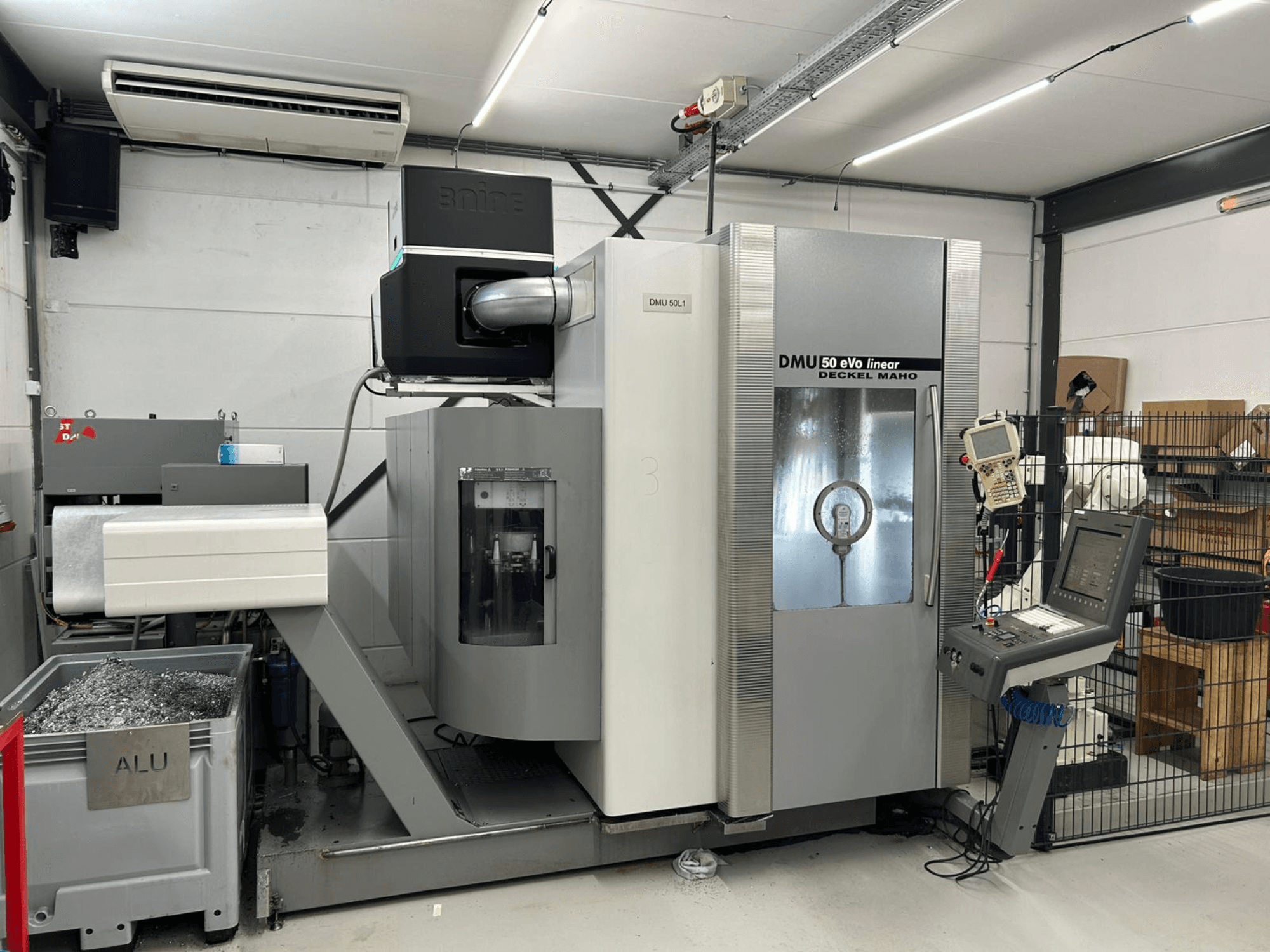 DMU 50 eVo linear milling machine by Deckel Maho, front view, featuring a control panel and shavings container.