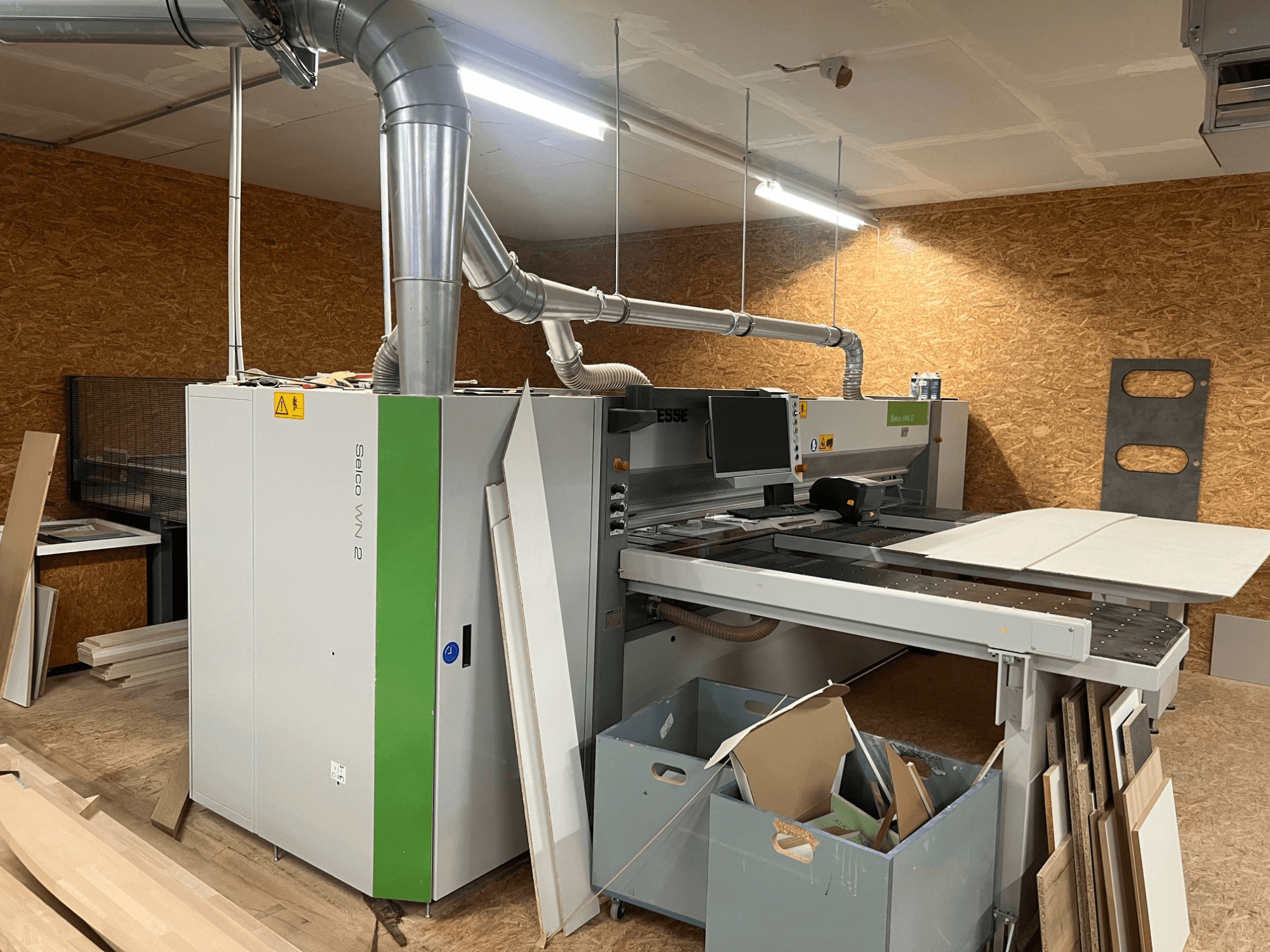 BIESSE Selco WN 2 panel saw in a workshop, featuring a large cutting table and dust extraction system, side view.