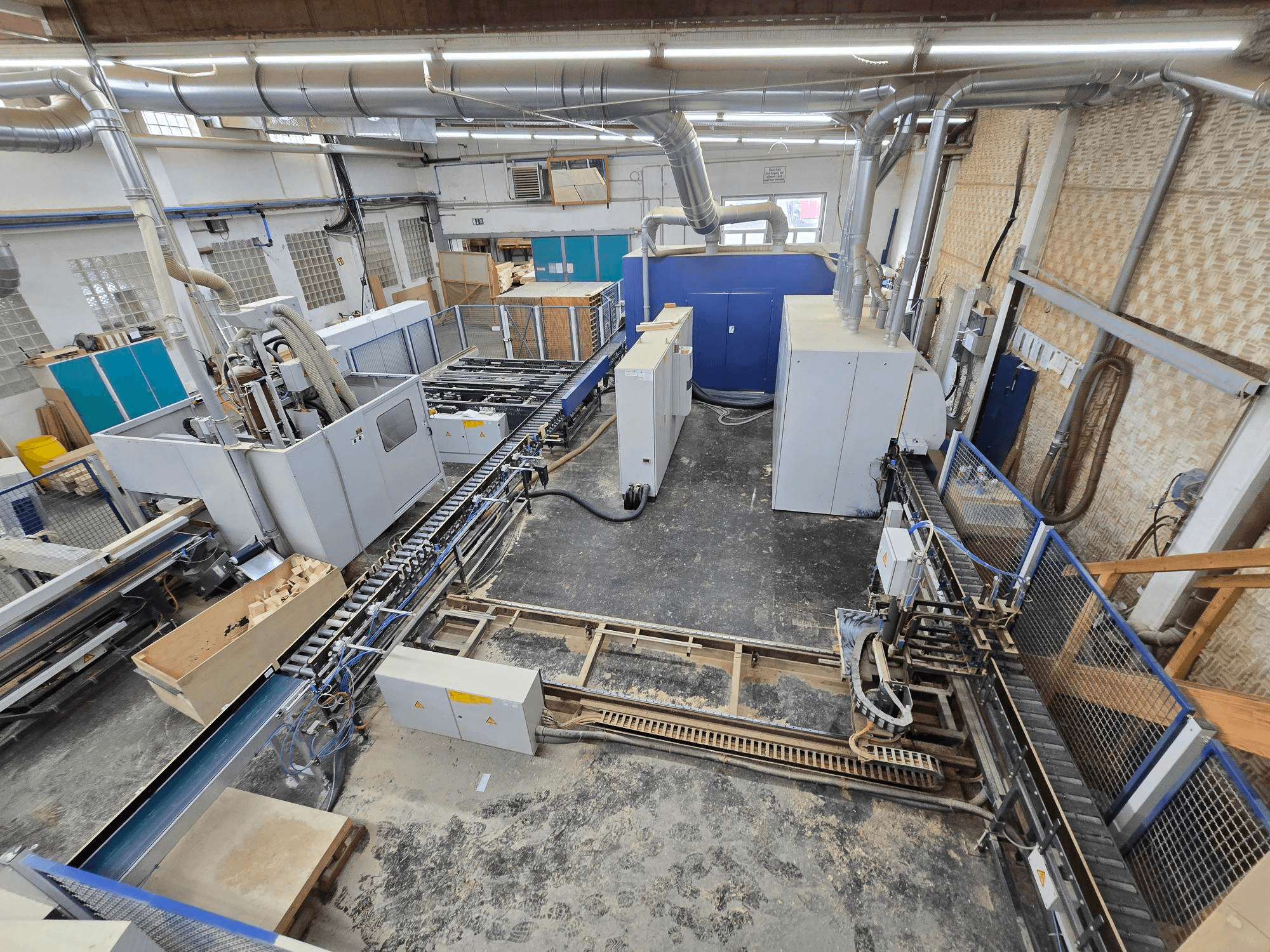 WEINIG DIMTER Unirex 2000 SPB complete wood production line in a factory setting, overhead view showcasing machinery and conveyor system.