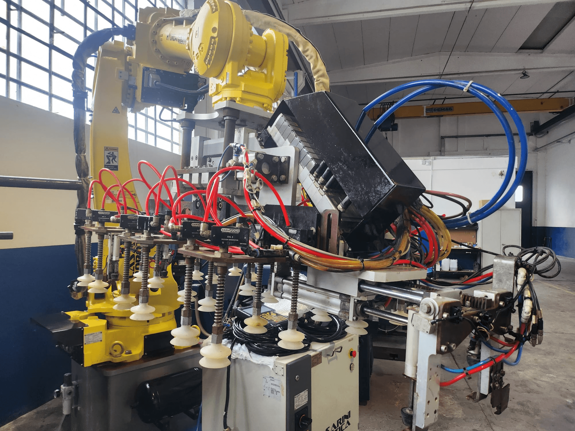 Hyundai Hi 5a-S robot arm from a front view, featuring multiple hoses, control components, and a complex arrangement of cables.