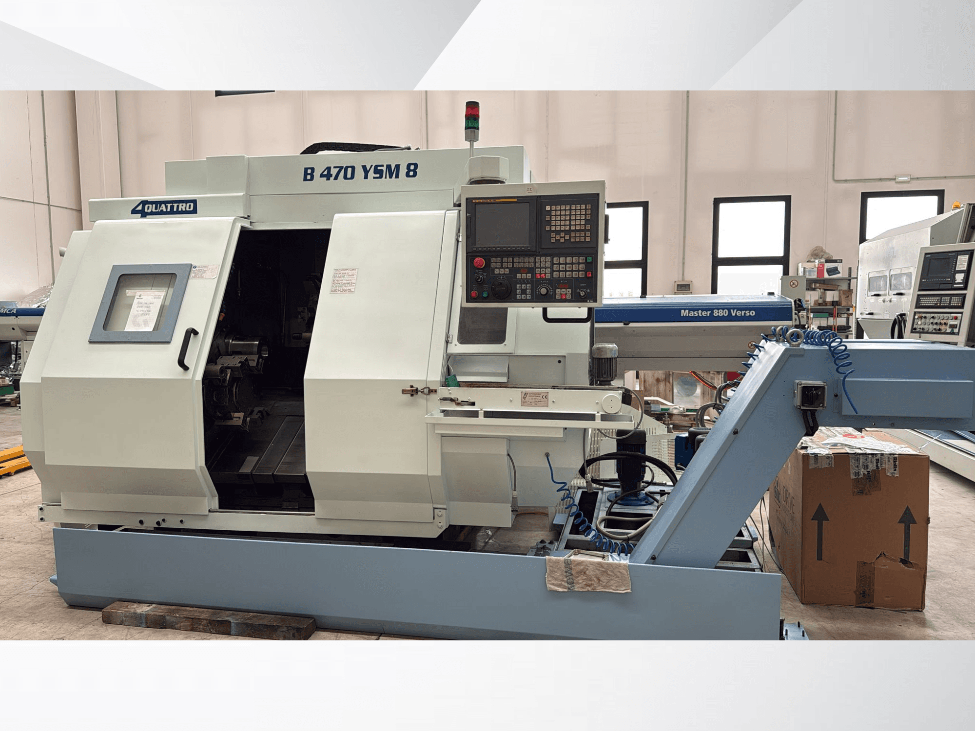 Biglia B470 YSM turn-mill center, front view showing control panel, opened hatch, and workspace with tools inside.