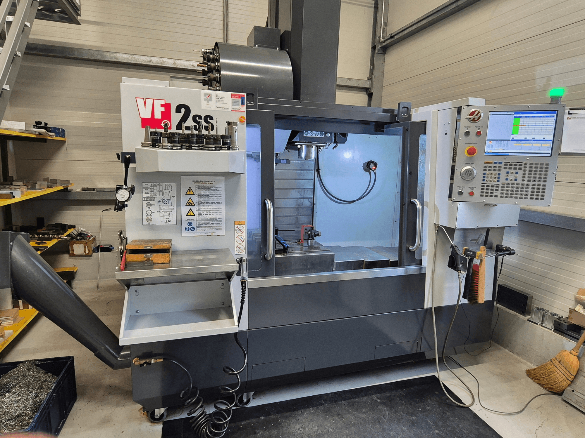 HAAS VF2 SS-EU vertical machining center in a front view, showcasing controls, spindle, and machining area.
