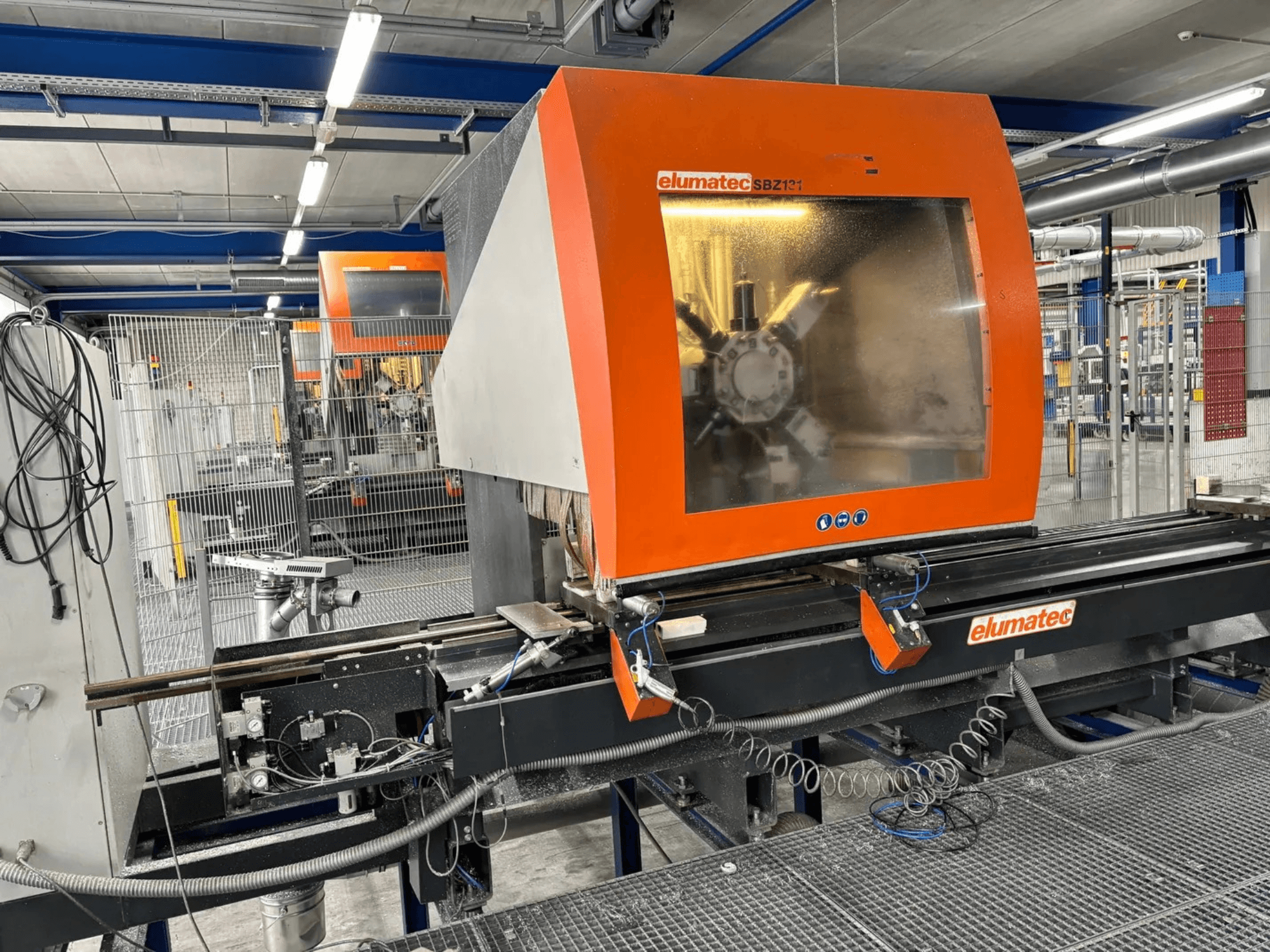 Elumatec SBZ 131 vertical machining centre, front view, showcasing control panel, machinery details, and surrounding work environment.