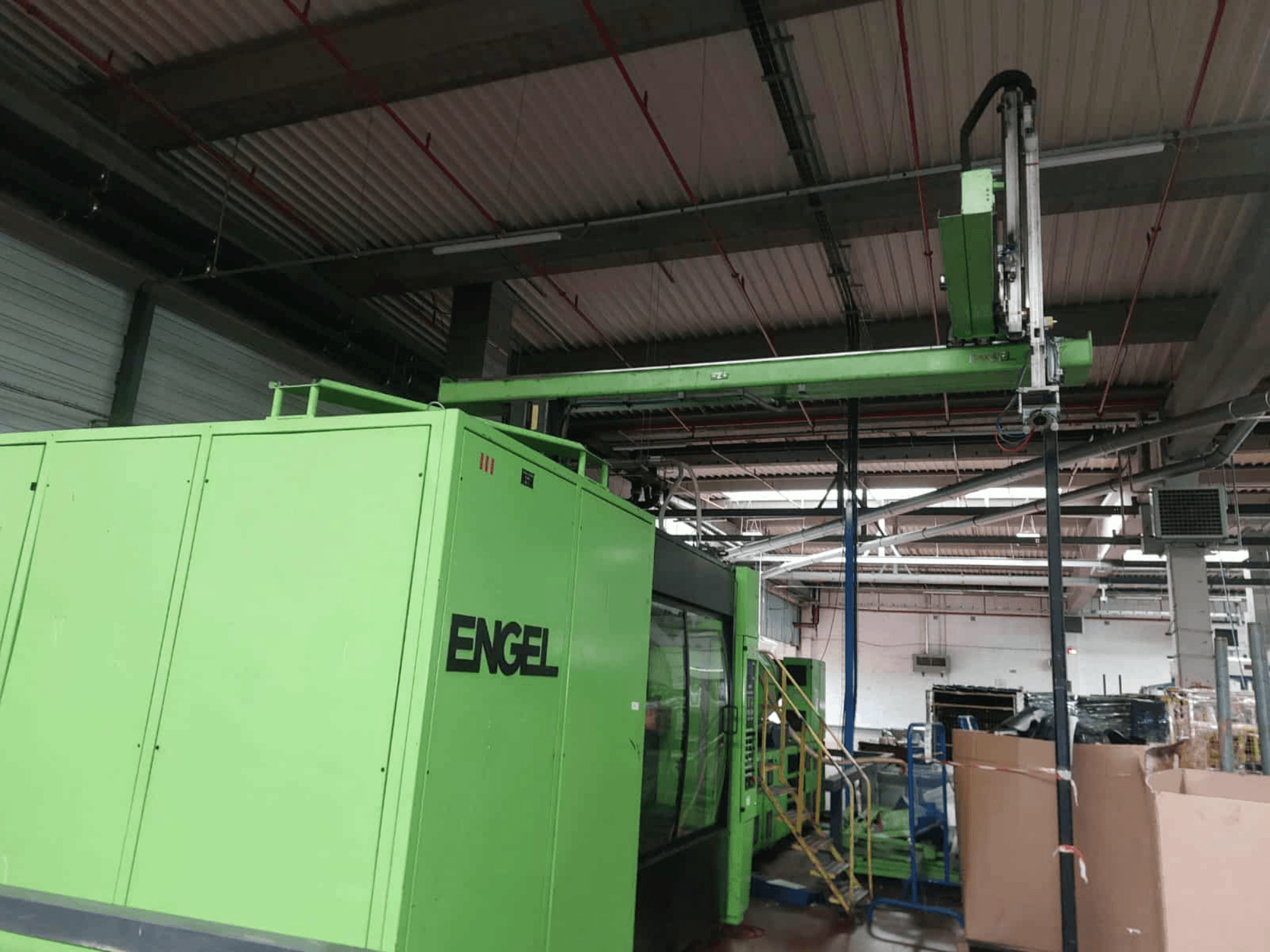 Green Engel ES 16050/1100 DUO hydraulic injection moulding machine, side view, showcasing loading area and control panel.
