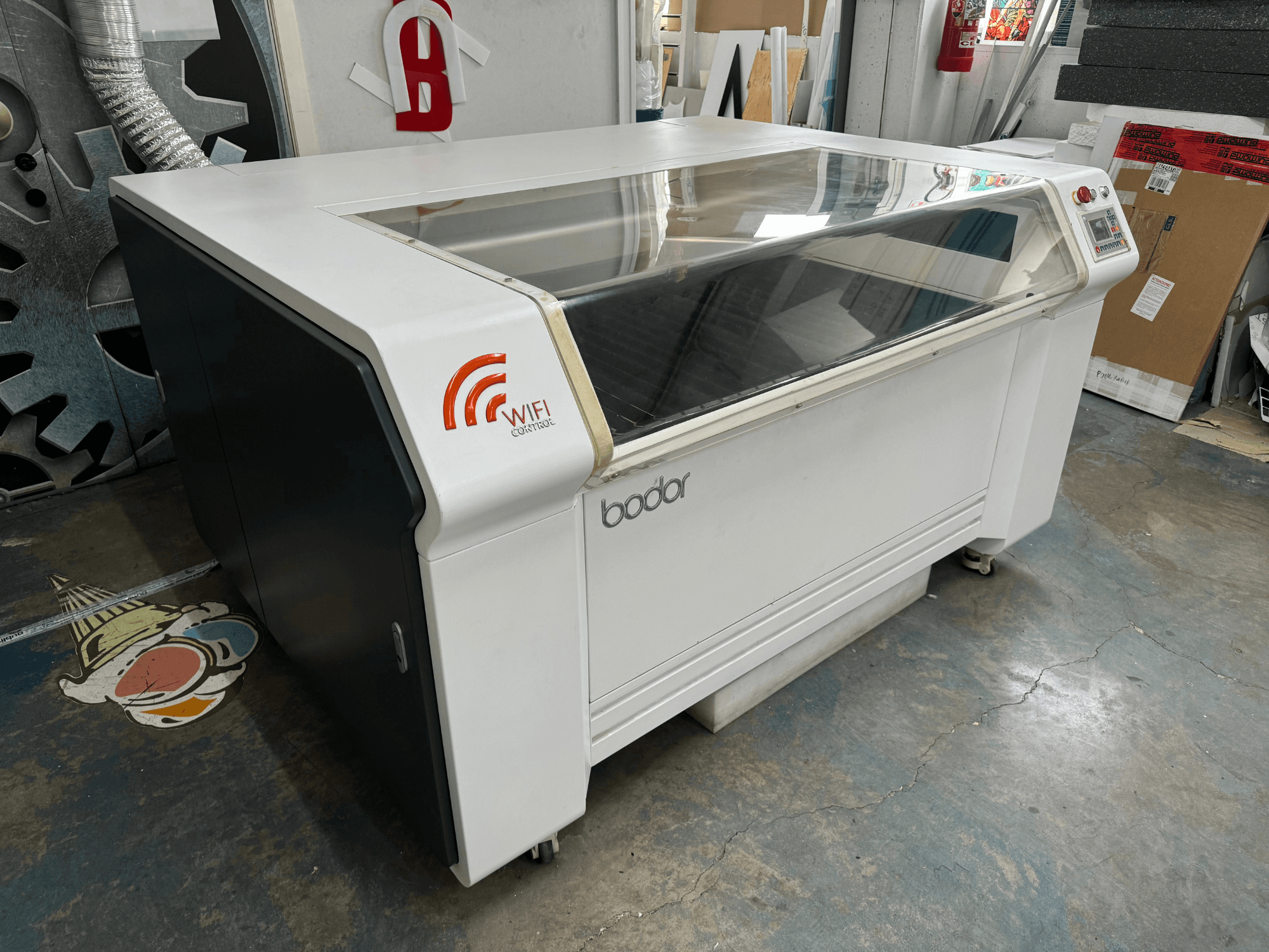Bodor laser cutting machine in white and black, side view, featuring WiFi control and a transparent lid.