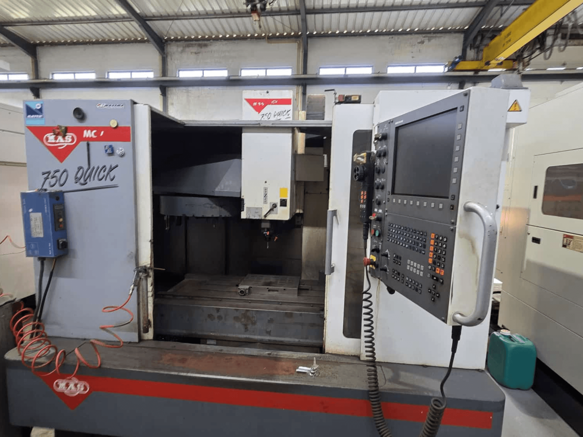 Vertical machining center KOVOSVIT MAS MCV 750, front view showing control panel and work area, with "750 Quick" labeling.