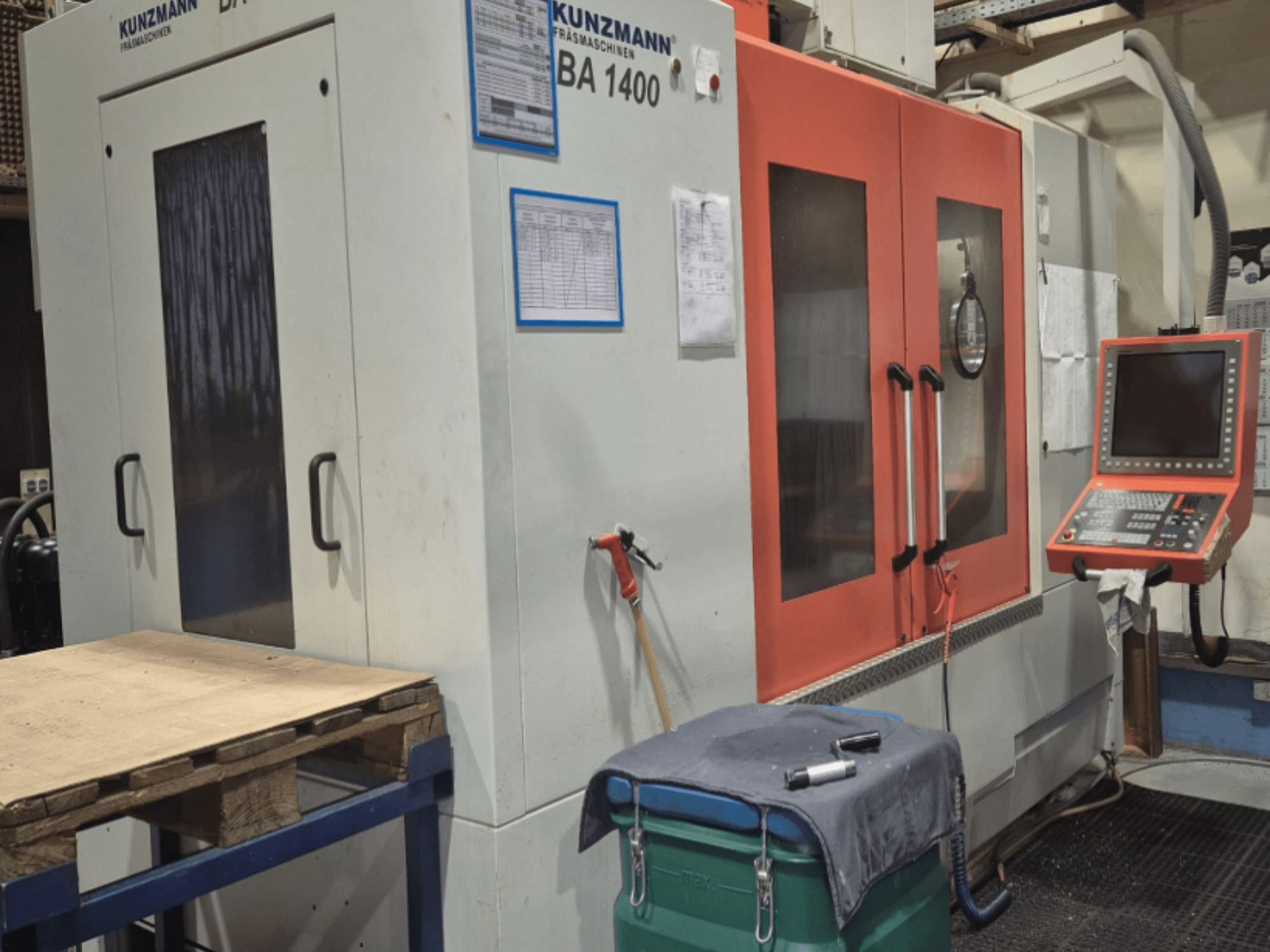 KUNZMANN BA1400 Vertical Machining Centre front view, featuring orange doors, control panel, and worktable.