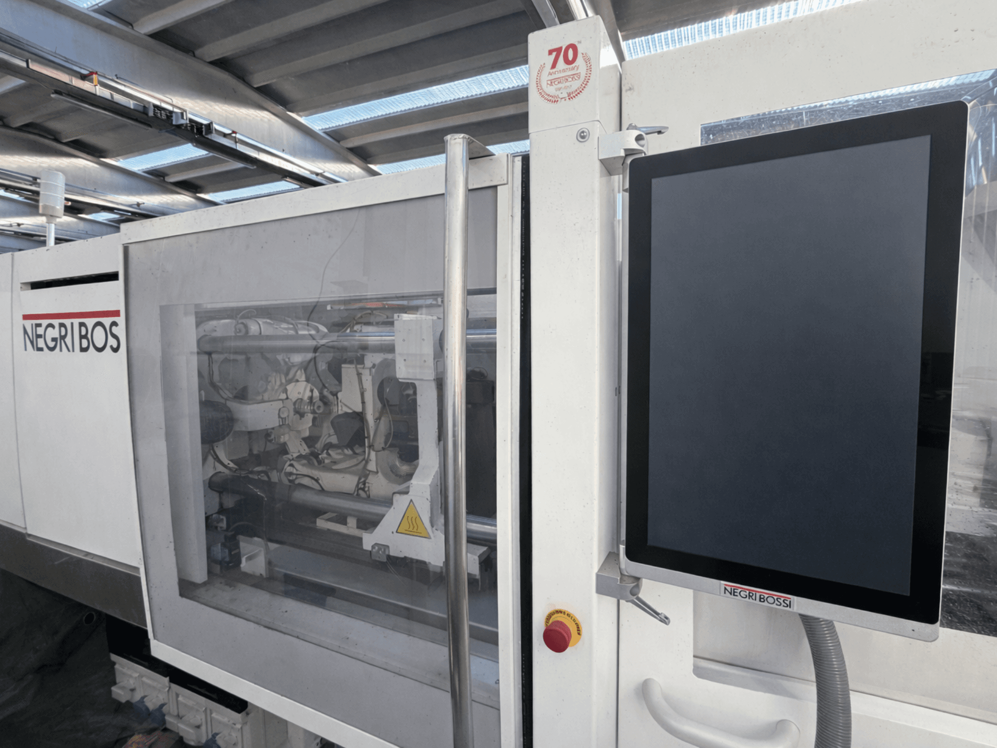 Negri Bossi ELE 80 electrical injection moulding machine, front view with control screen and visible internal components.