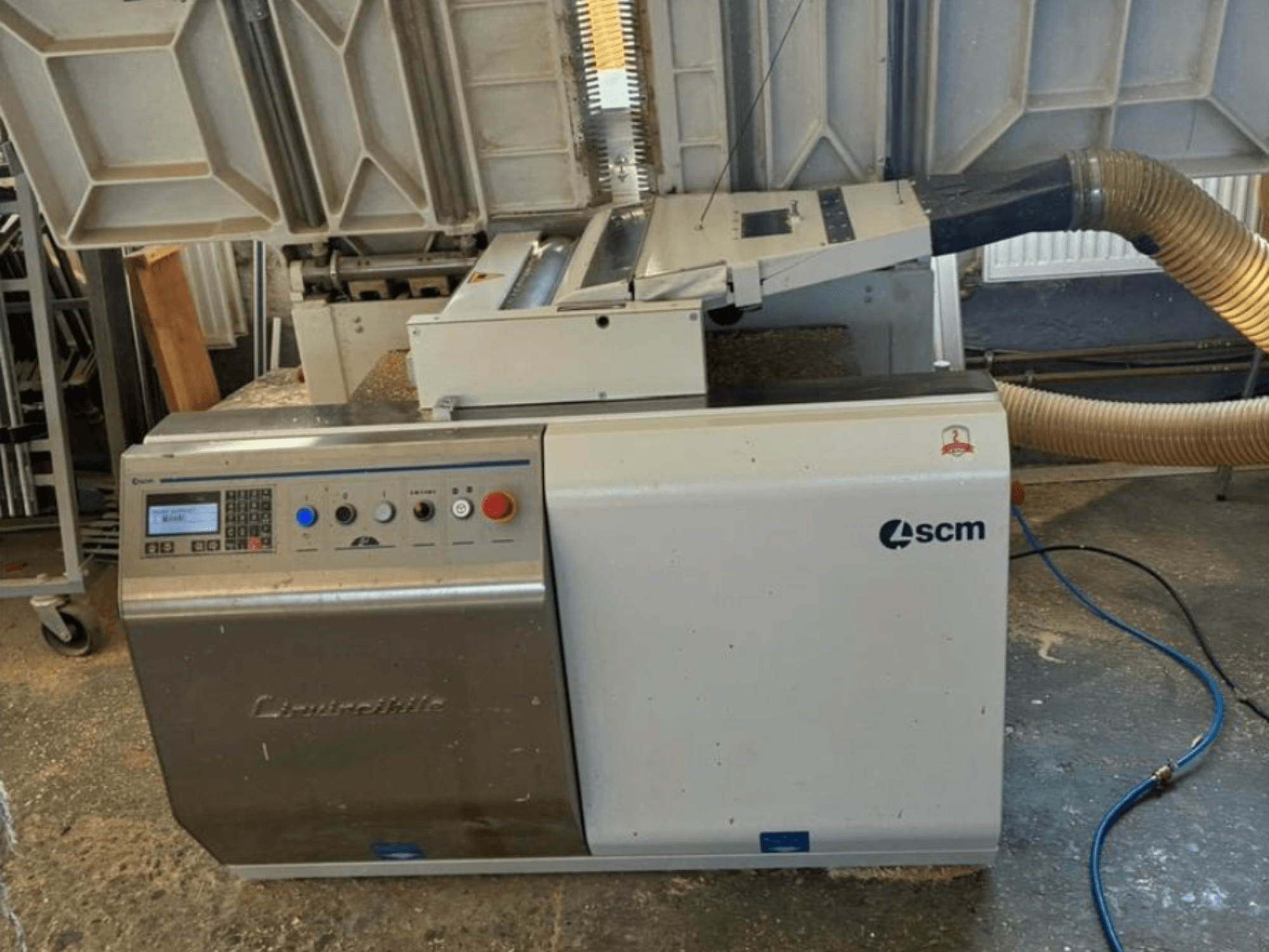 SCM Centauro edge banding machine in front view, showing control panel, suction hose, and open work area for edge application.