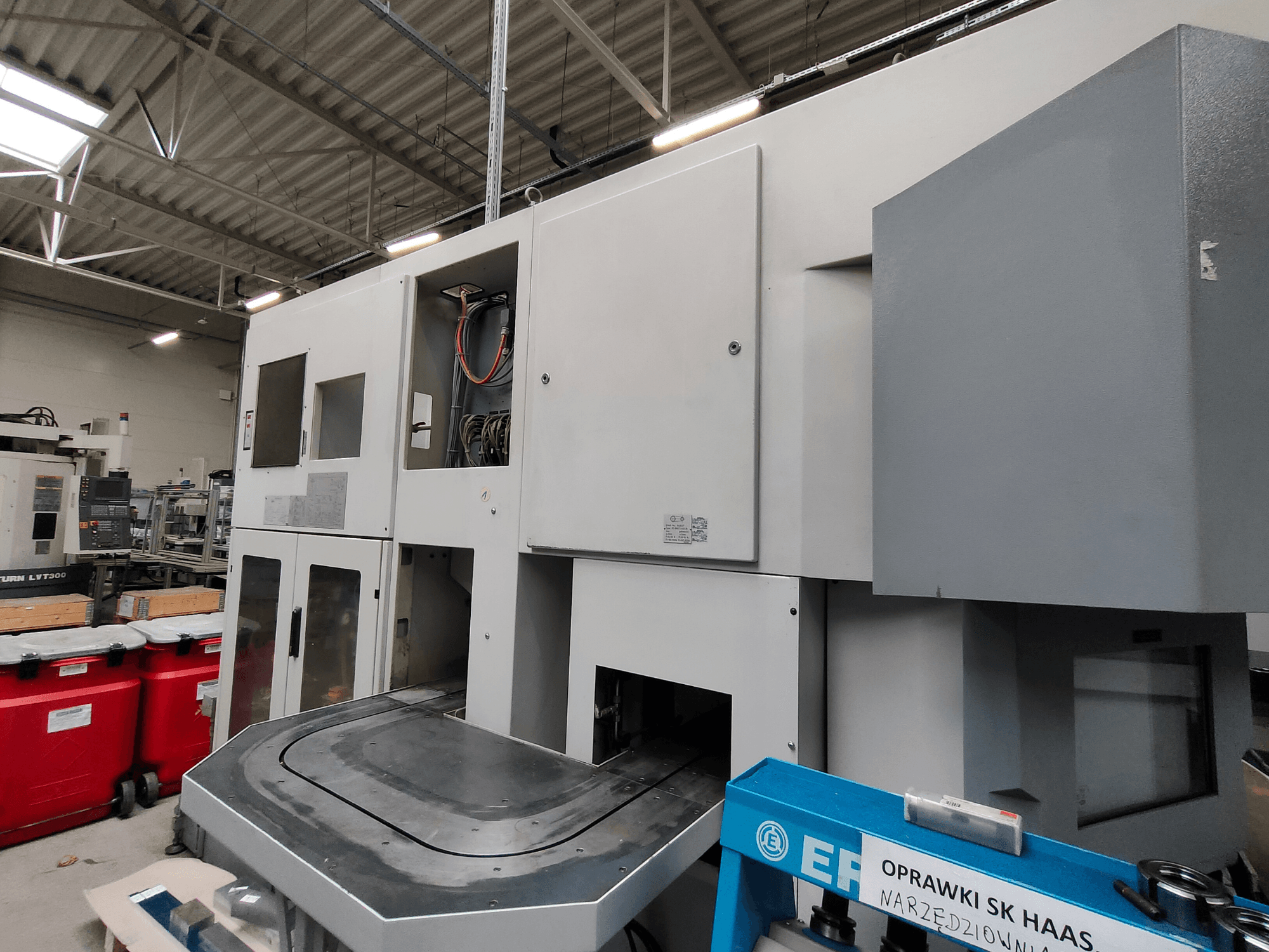 EMAG VSC 250 vertical turning machine shown from the side, featuring control panels and a large working area.