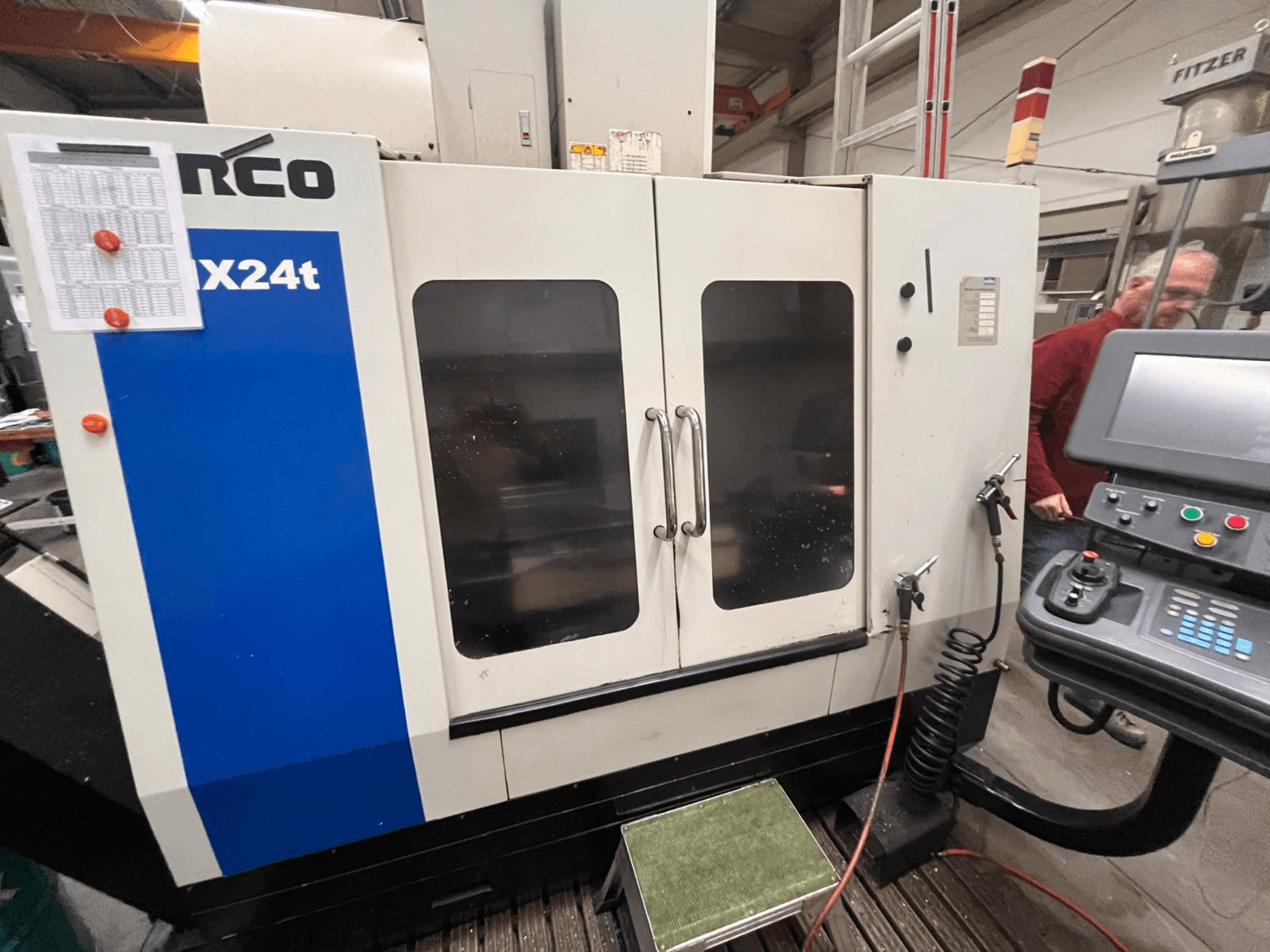 Vertical machining center by Hurco, model VX24t, shown from the front with control panel and transparent doors.