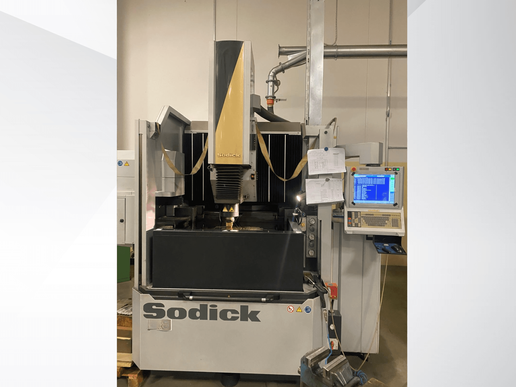 Sodick EDM machine in front view, featuring a control panel, work table, and an overhead cutting head.
