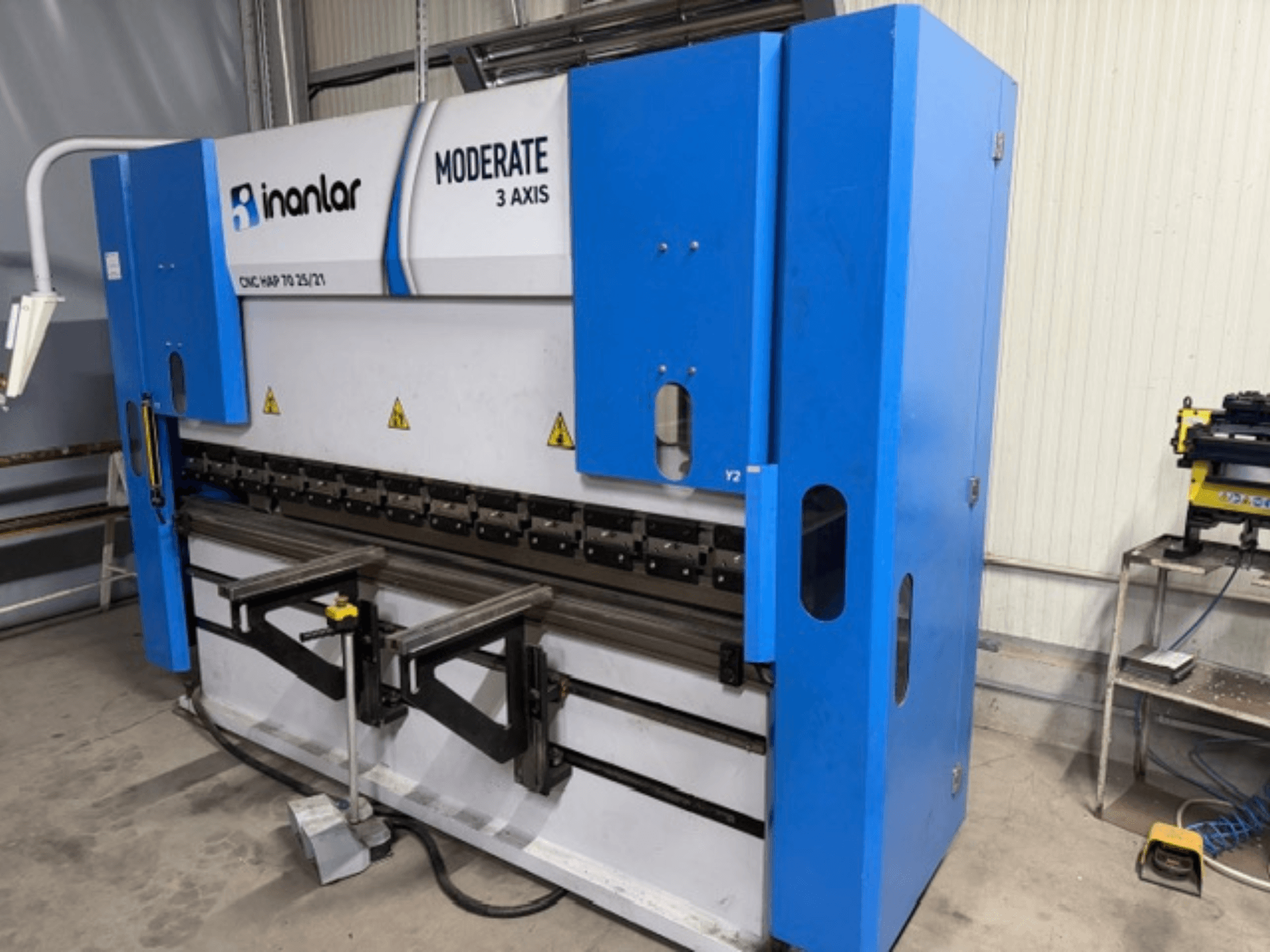 Inanlar Moderate 3 Axis CNC machine in blue, front view, features control levers and safety labels visible on the body.