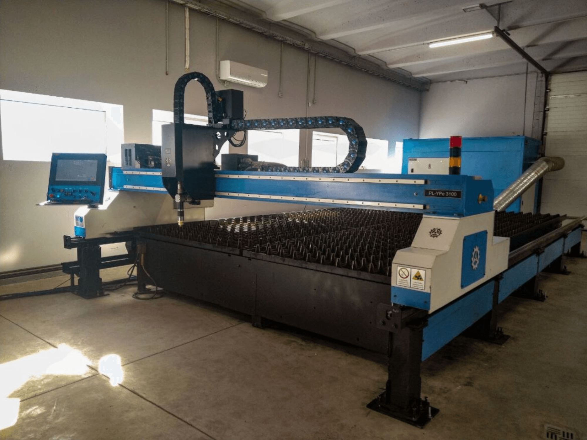 PL-YP© 3100 CNC cutting machine with display, front view, featuring a metal cutting bed and precise nozzle guidance system.