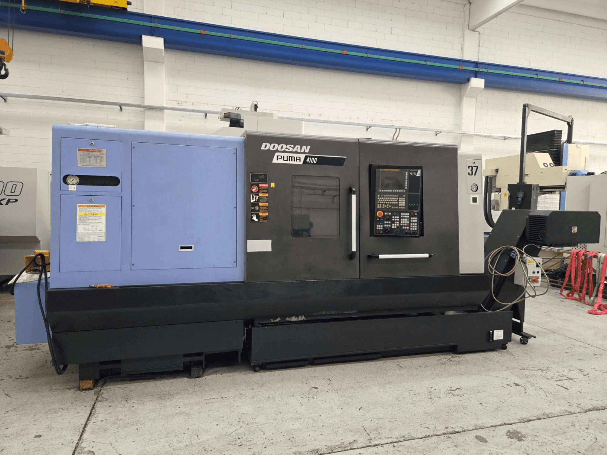 Doosan Puma 4100 CNC lathe, front view; features control panel, blue power unit, and detailed labels for operational guidance.