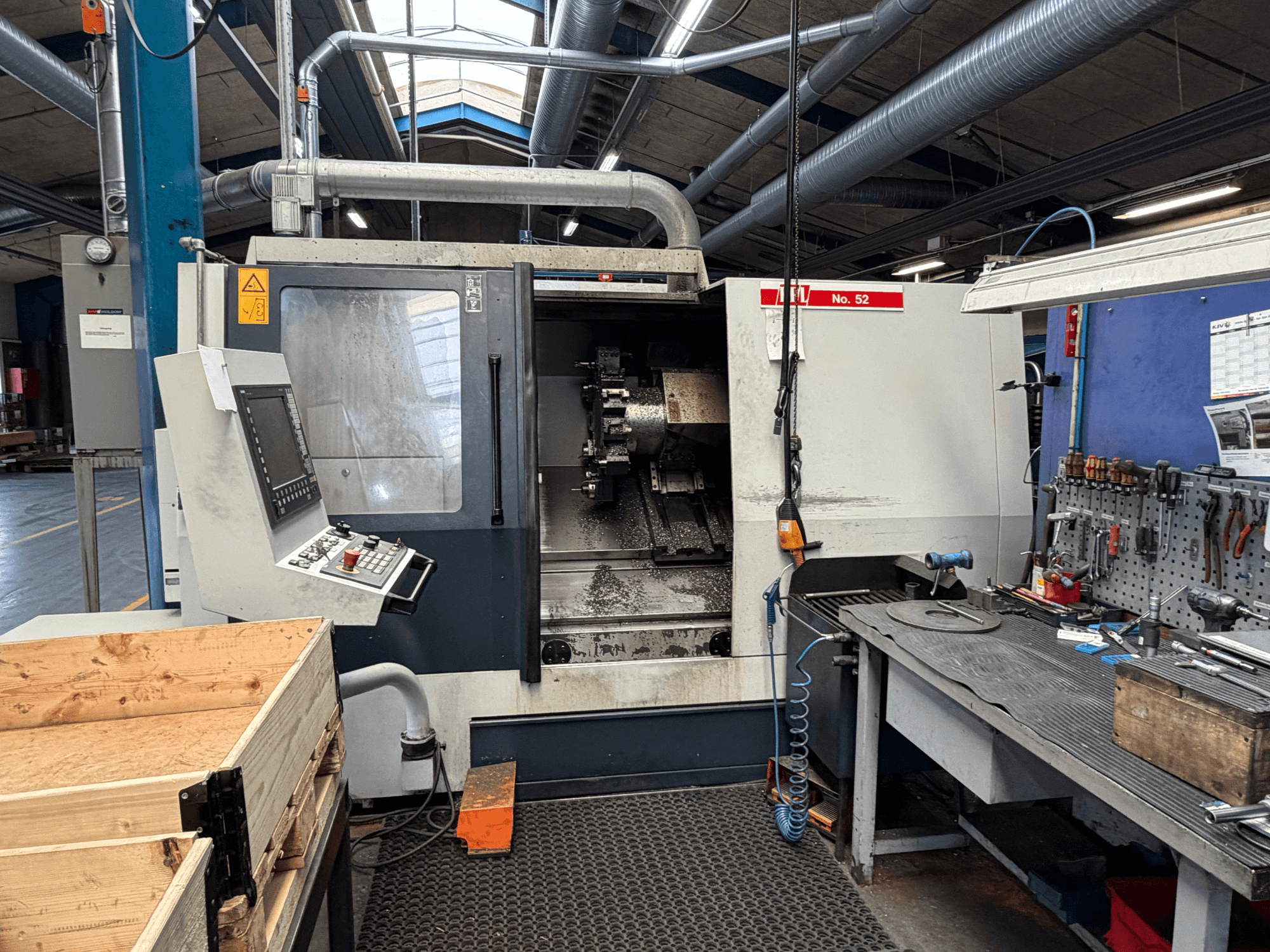 SPINNER TC800 110 SMCY horizontal turning machine, seen from the front, with control panel and nearby workspace.