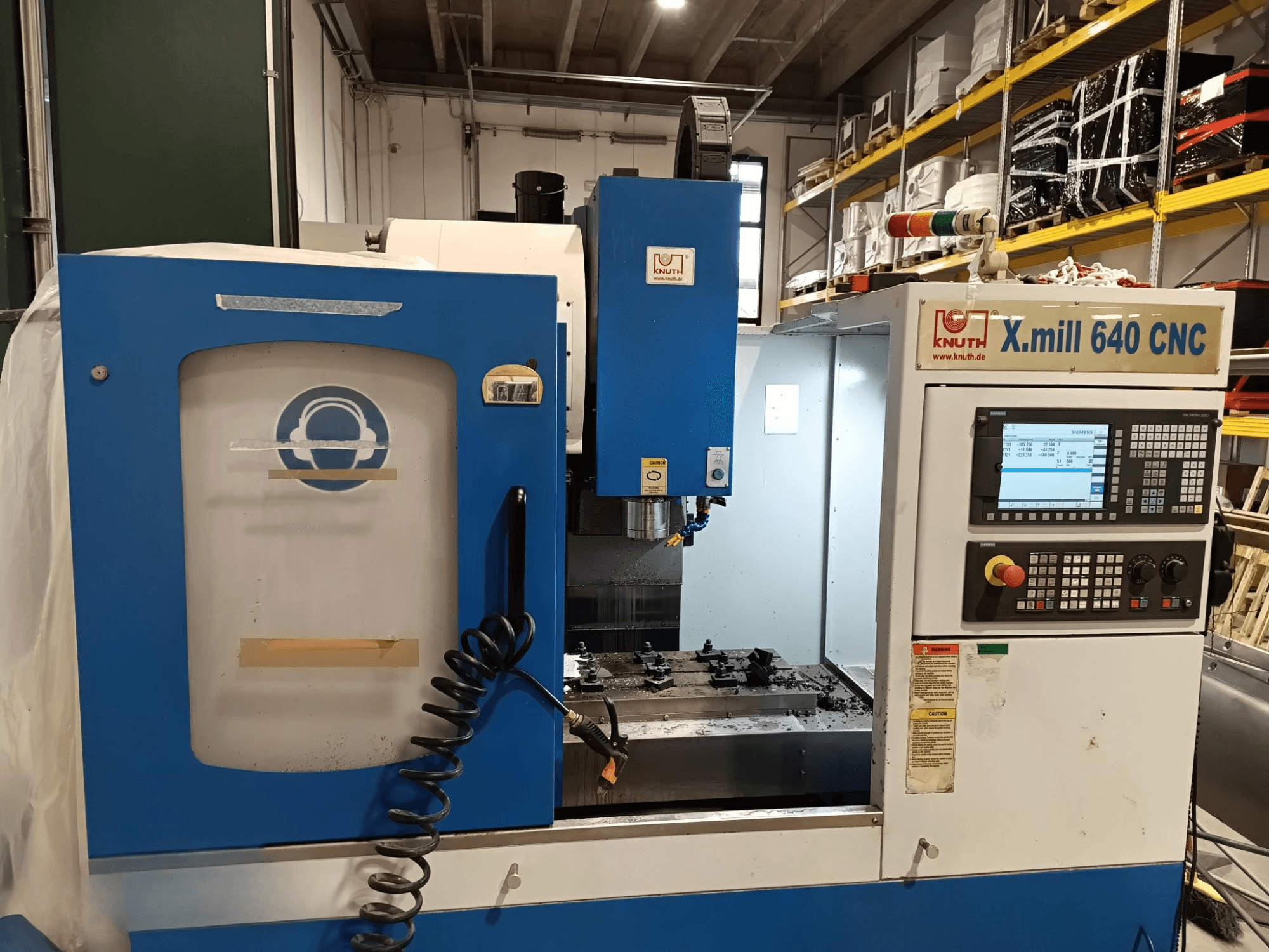 Knuth X.mill 640 CNC machine in side view, featuring a control panel, spindle area, and visible workpiece setup.