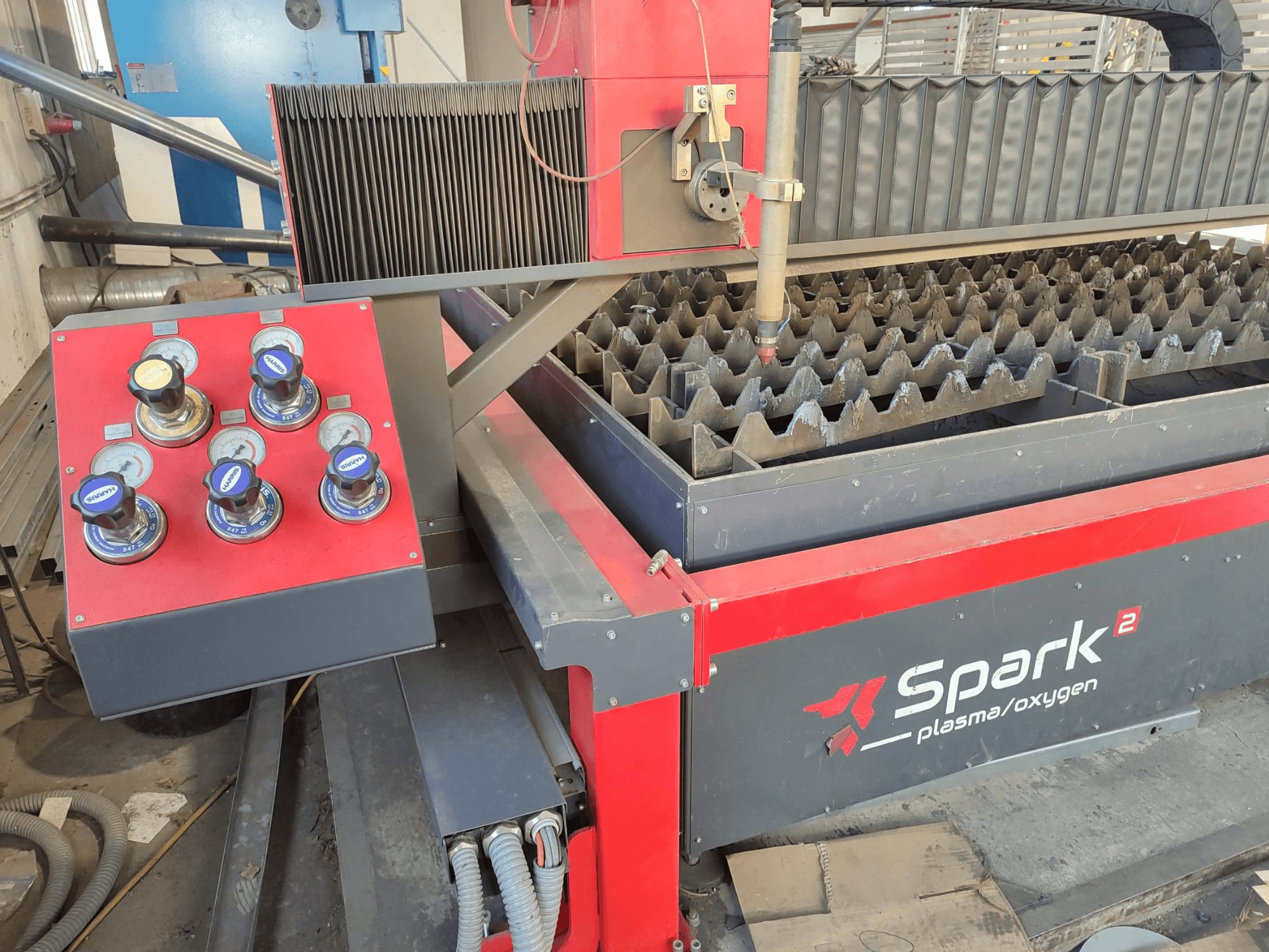 Spark 2 plasma/oxygen cutting machine, front view, showing control panel with six gauges and cutting bed with textured surface.