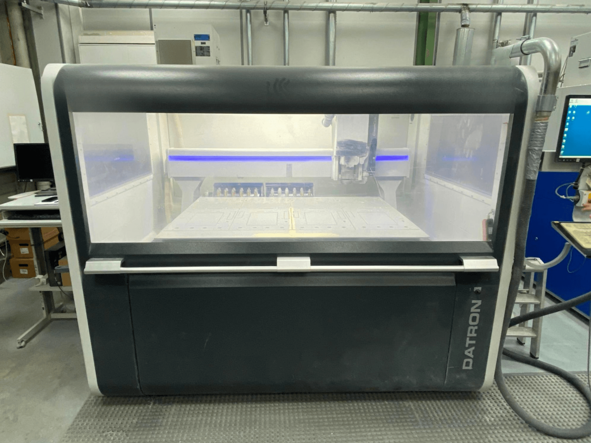 Front view of Datron MLCube B Vertical Machining Centre, showcasing the transparent enclosure and control panel.