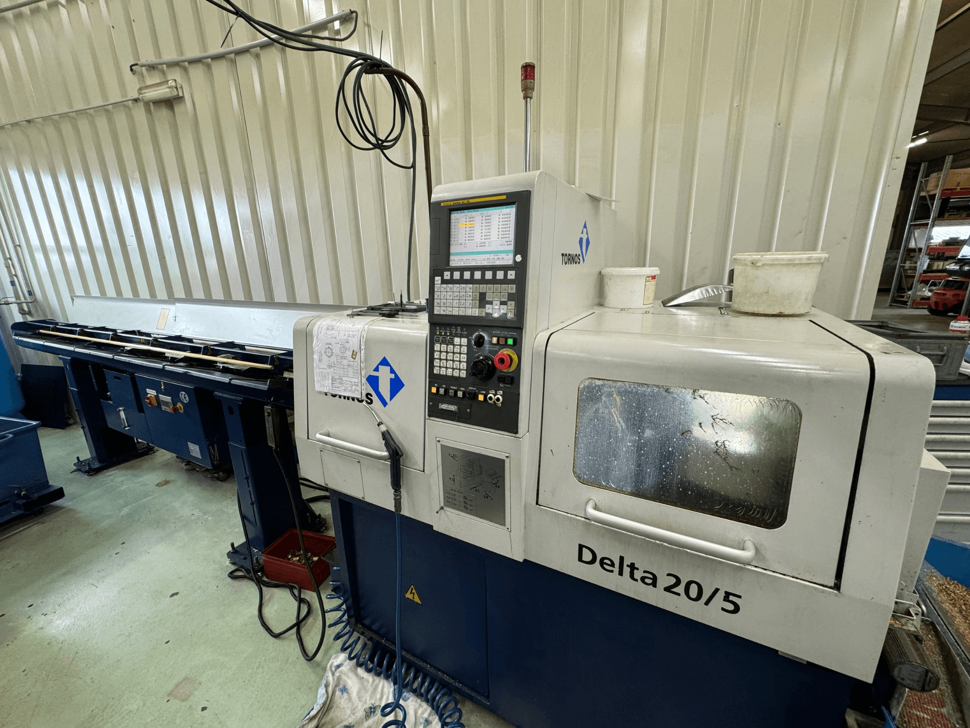 Torino Delta 20/5 CNC machine, front view, with control panel and workspace. Features etched glass and visible wiring.