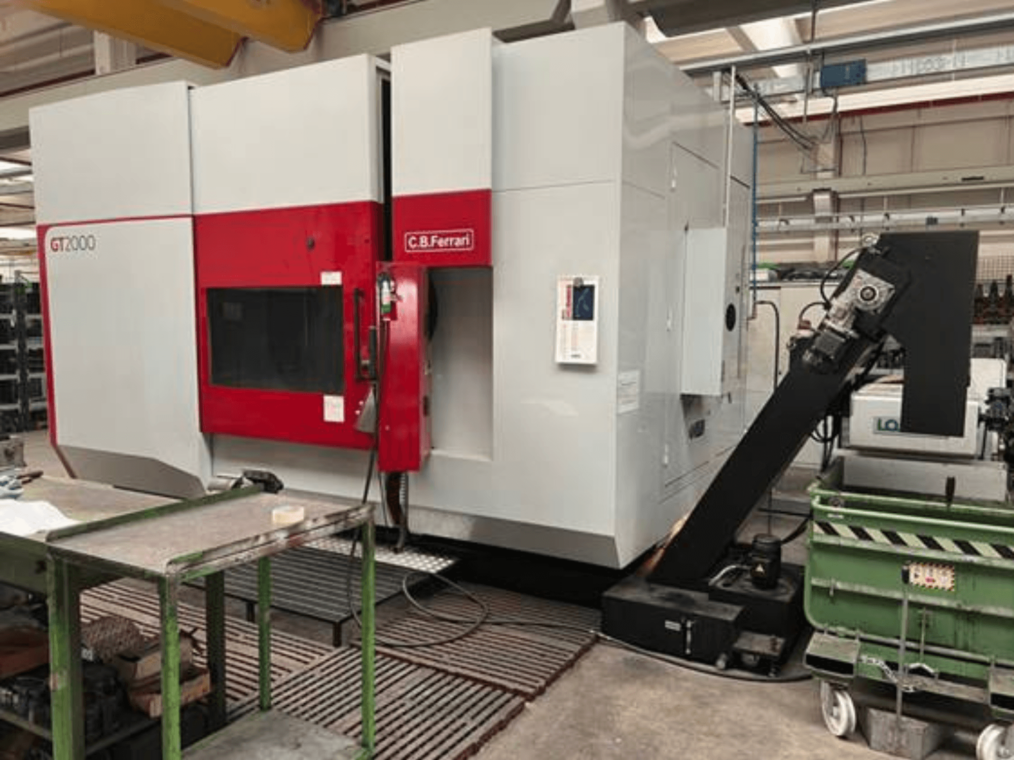 C.B. Ferrari GT2000 milling machine in a front view, featuring a robotic arm and industrial workspace with green cart.