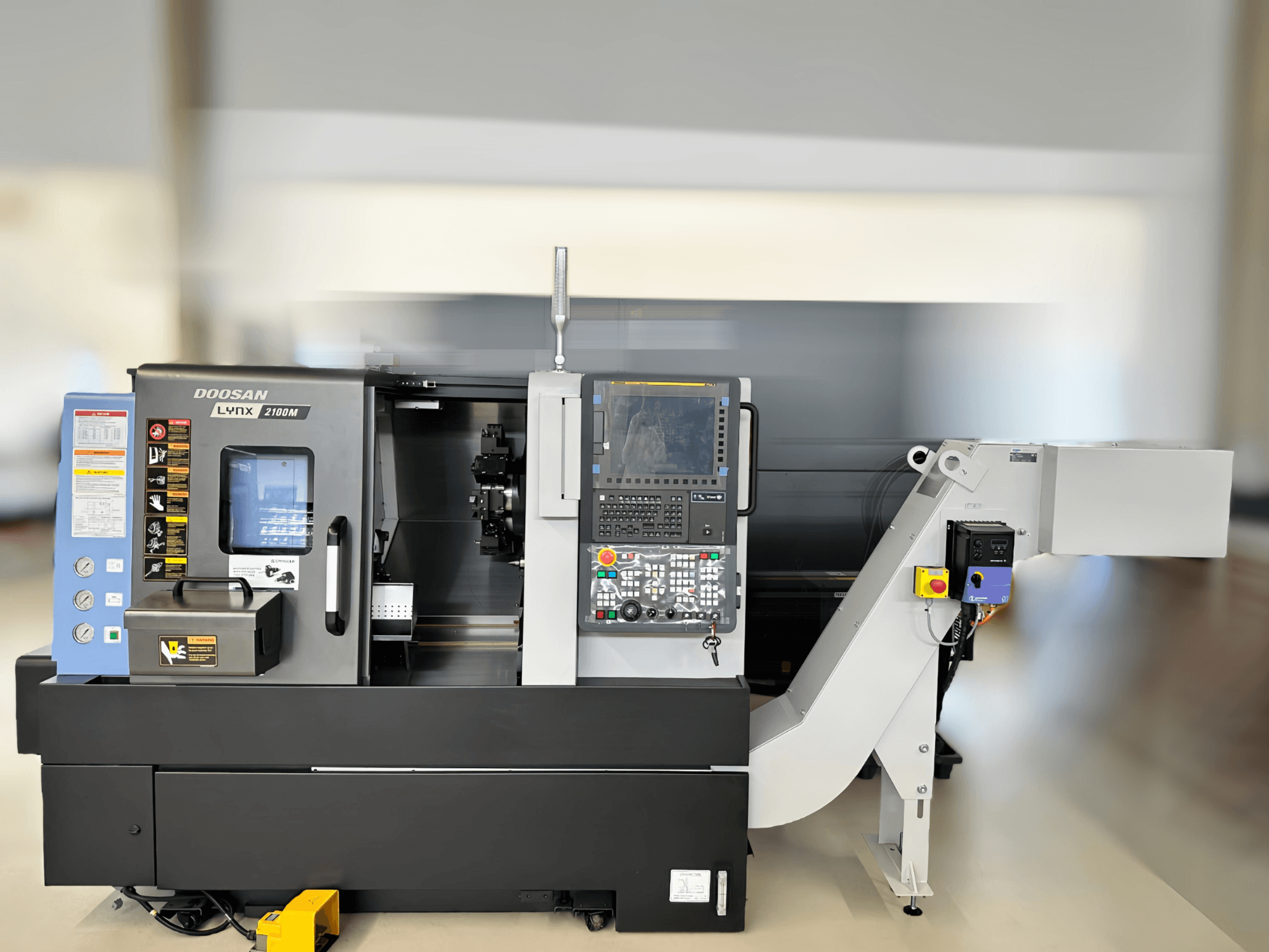 Front view of DN SOLUTIONS LYNX 2100MB horizontal turning machine, showing control panel and work area details.