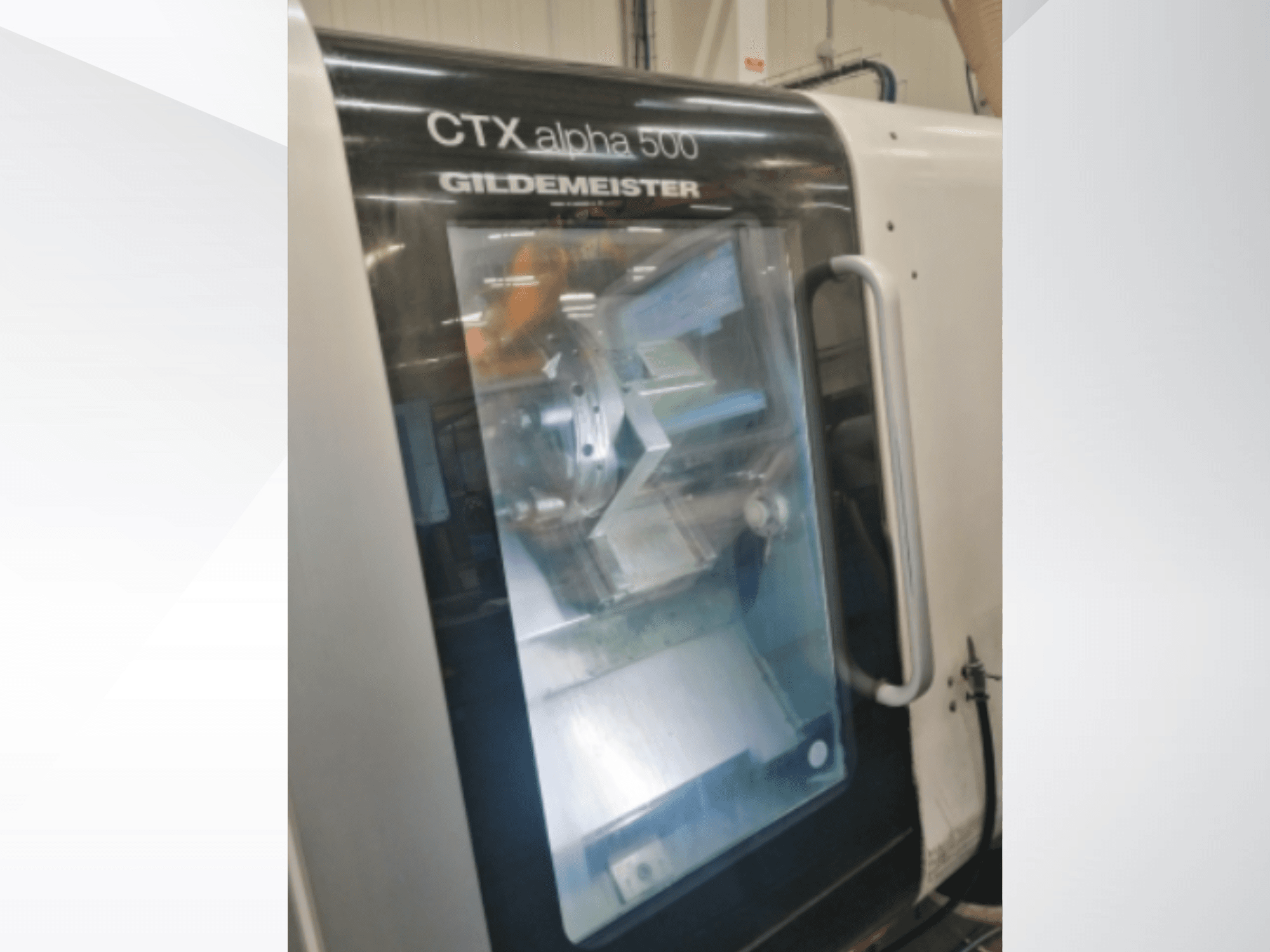 CTX alpha 500 Gildemeister CNC machine, front view, showing the spindle and machining area through glass door.