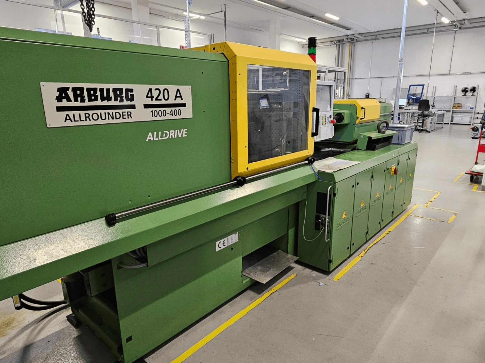 ARBURG 420 A Allrounder 1000-400, front view; green machine with yellow panel, touchscreen, and safety features.