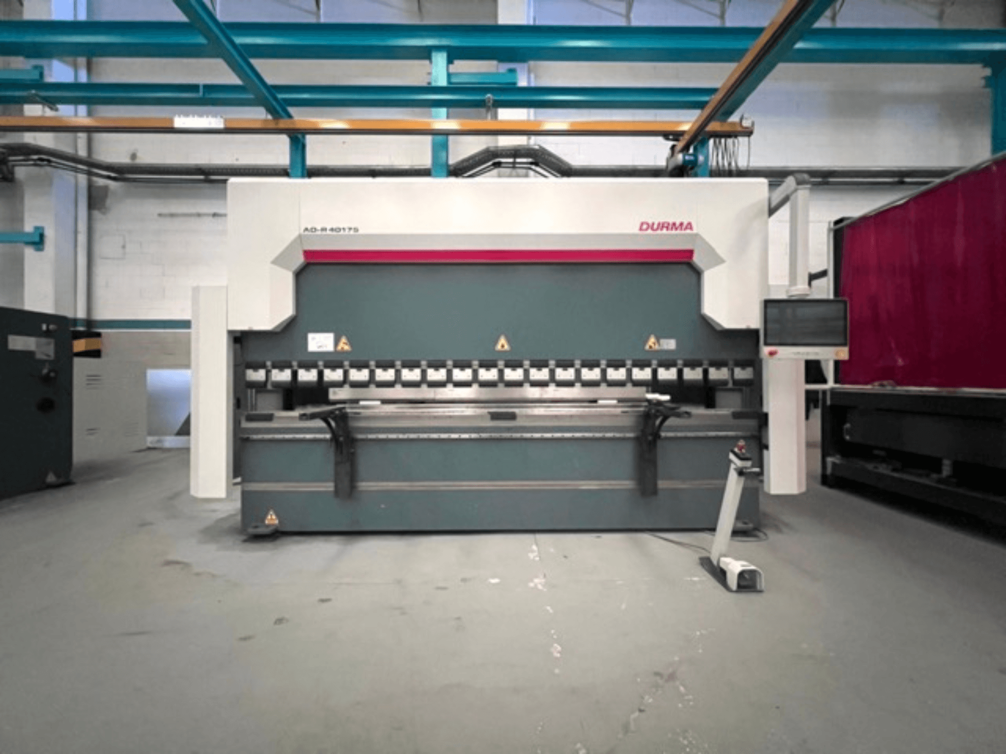 Durma AD-R 40175 press brake, front view, features a control panel and multiple bending mechanisms in a workshop setting.