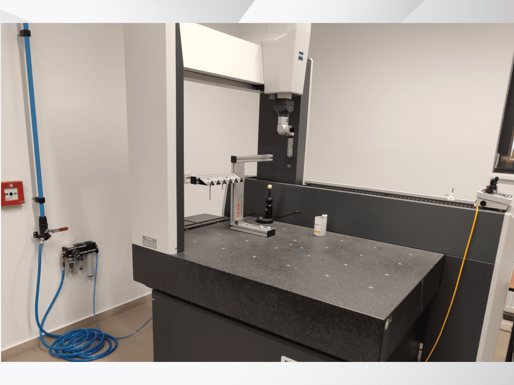MSR measurement device in a lab, front view showcasing a granite table, calibration sphere, and connected utilities.