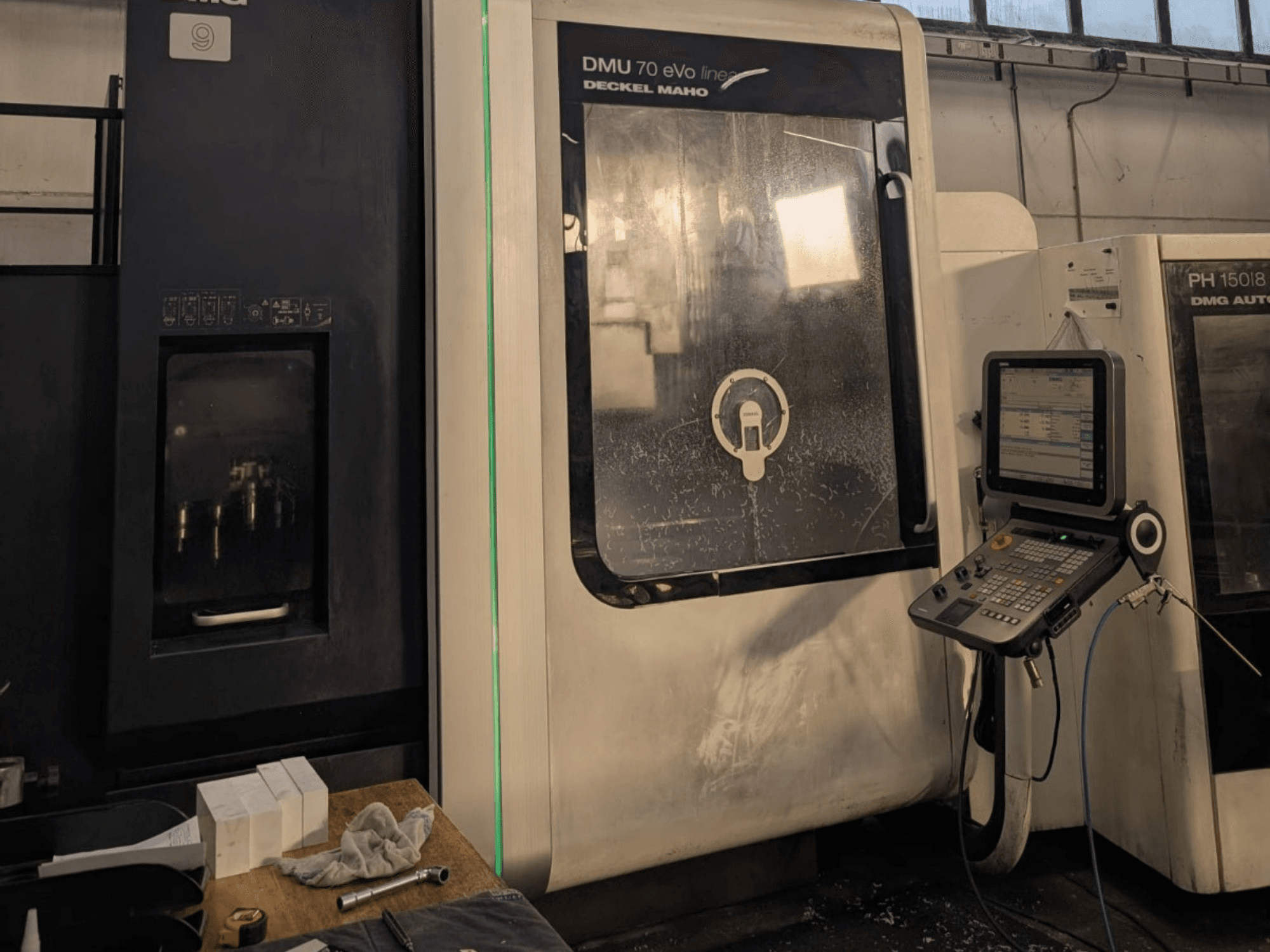 DMG DECKEL MAHO DMU 70 EVO Linear vertical machining centre, front view with control panel, tools, and workspace visible.