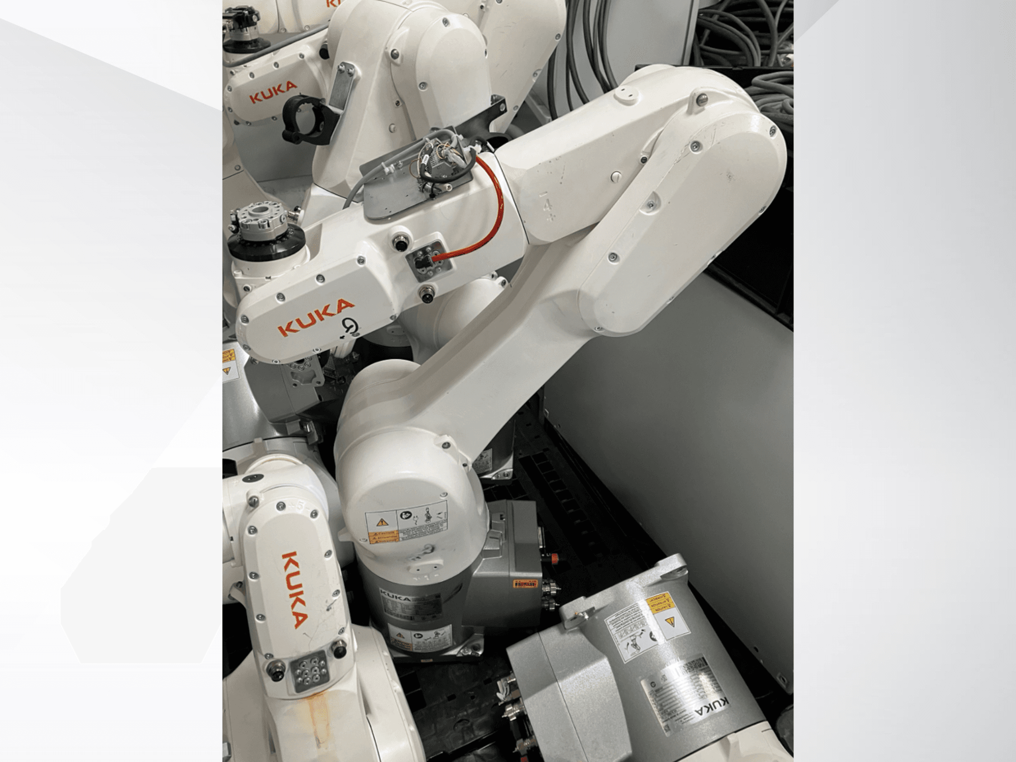 KUKA KR 6 R900 CR robot arm, side view; features visible motors and connectors, labeled safety warnings, and mechanical arms.