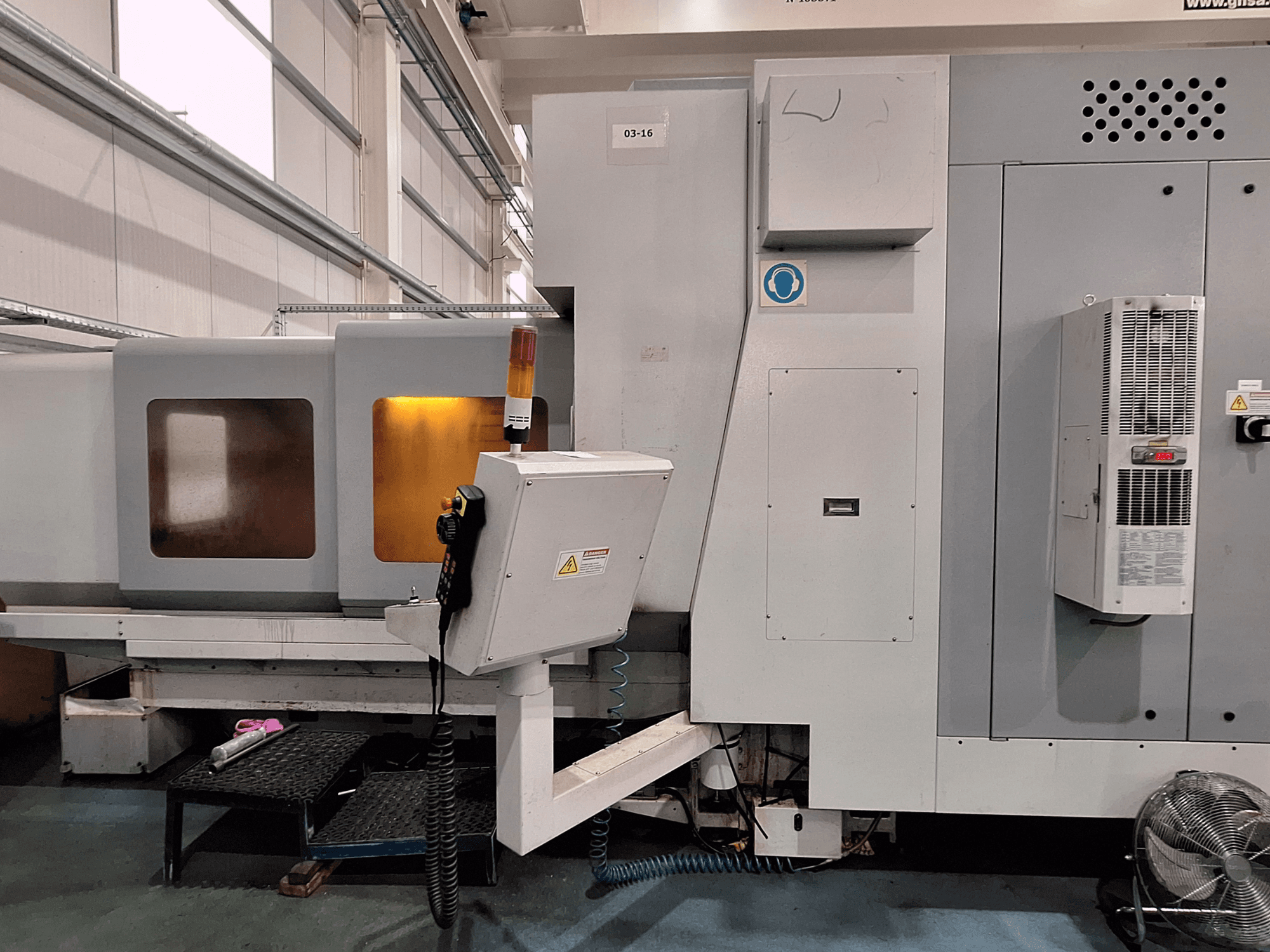 Eumach LBM-2000 bed type milling machine, front view, showing control panel, safety lights, and milling area with windows.
