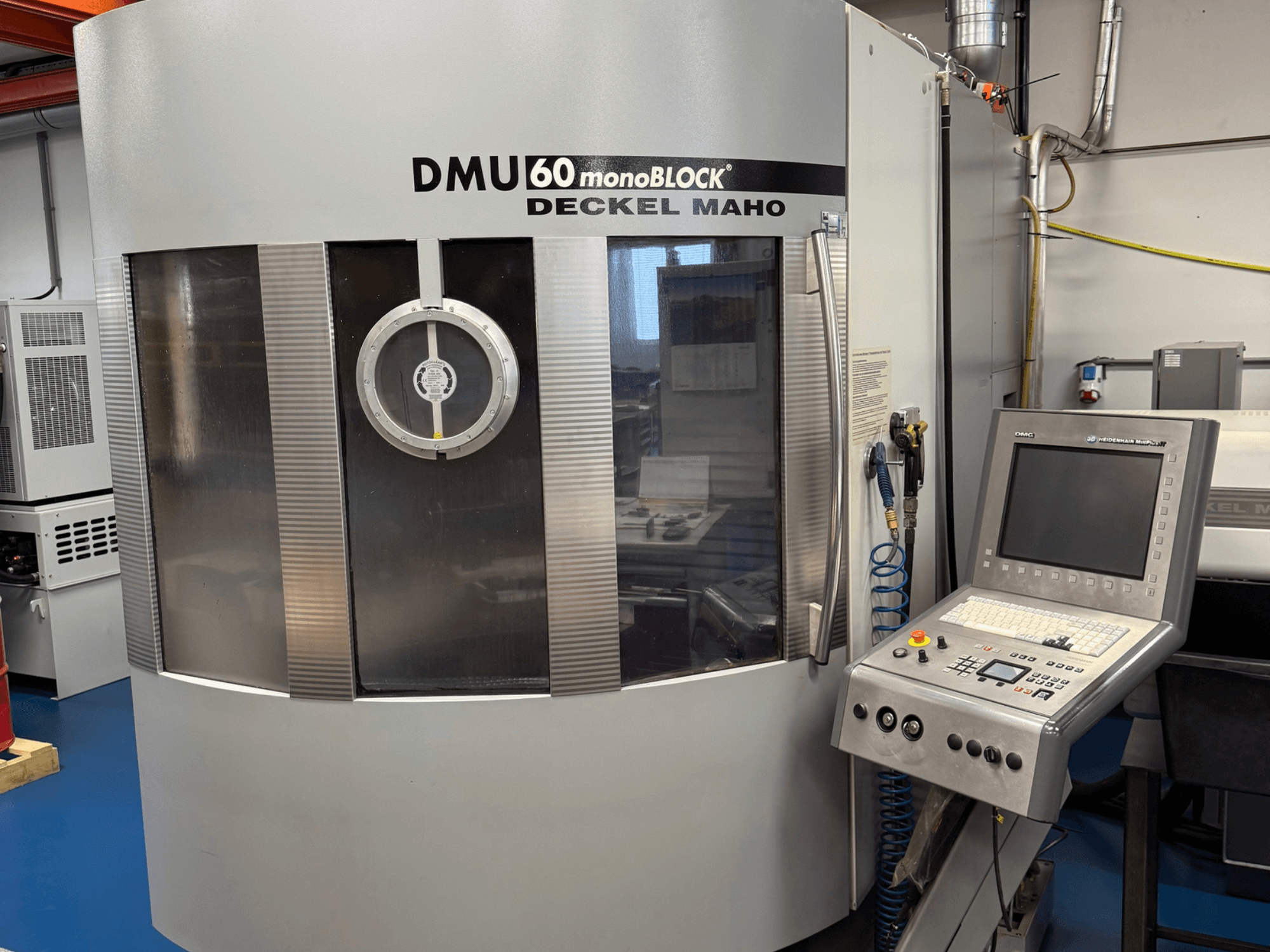 DECKEL MAHO DMU 60 monoBLOCK vertical machining center, front view with control panel and spindle access window visible.