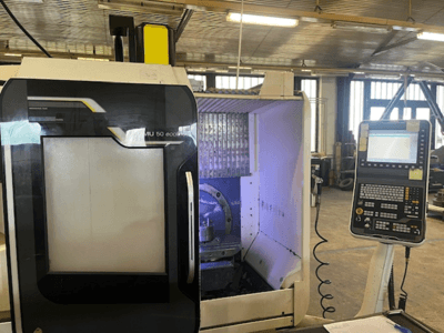 DMU 50 eco milling machine front view with control panel, displaying tool holder and workspace.