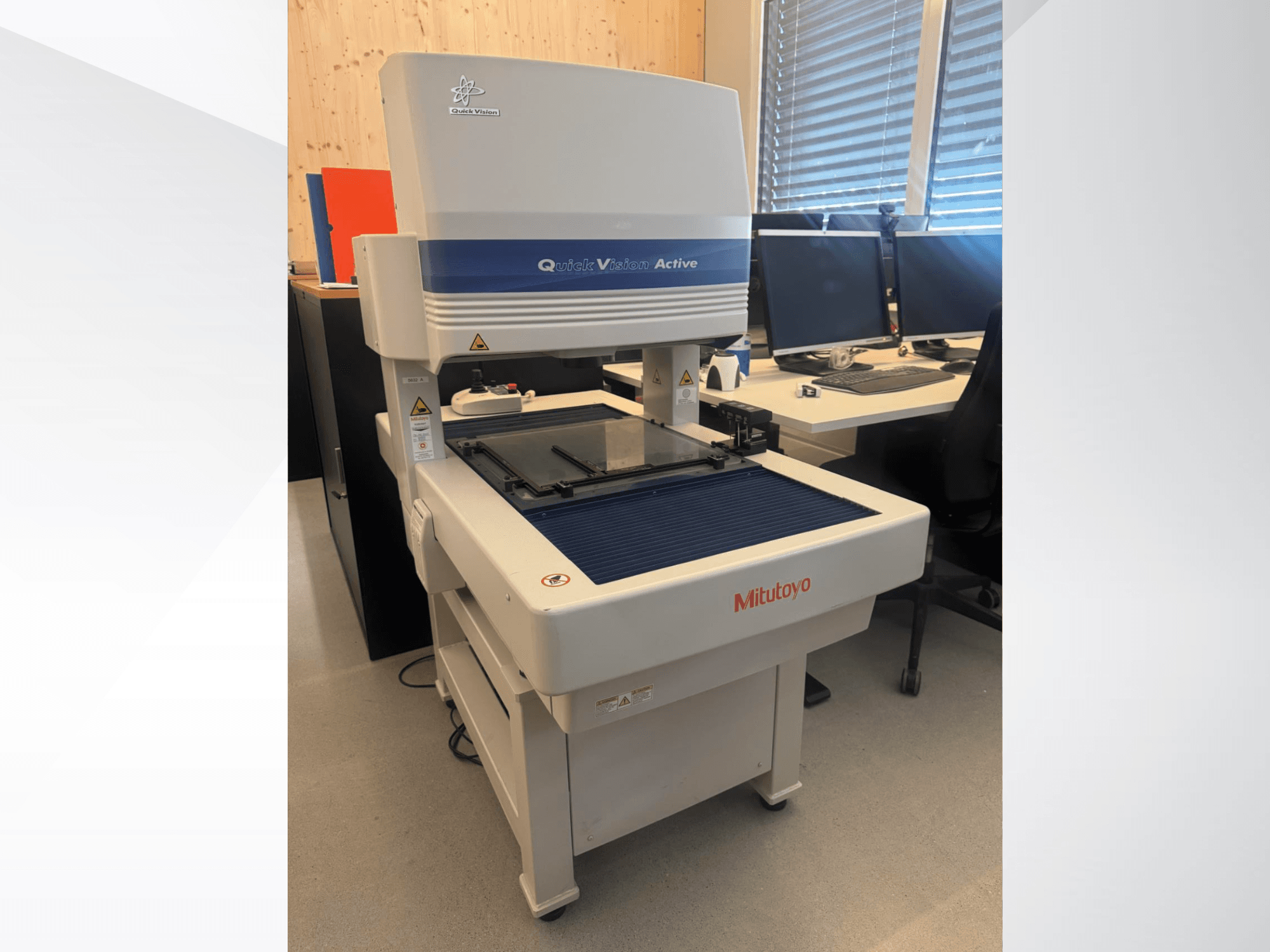 Mitutoyo QV-L404Z1L-D CMM in a front view, featuring a glass measurement table and visible control panel with buttons.