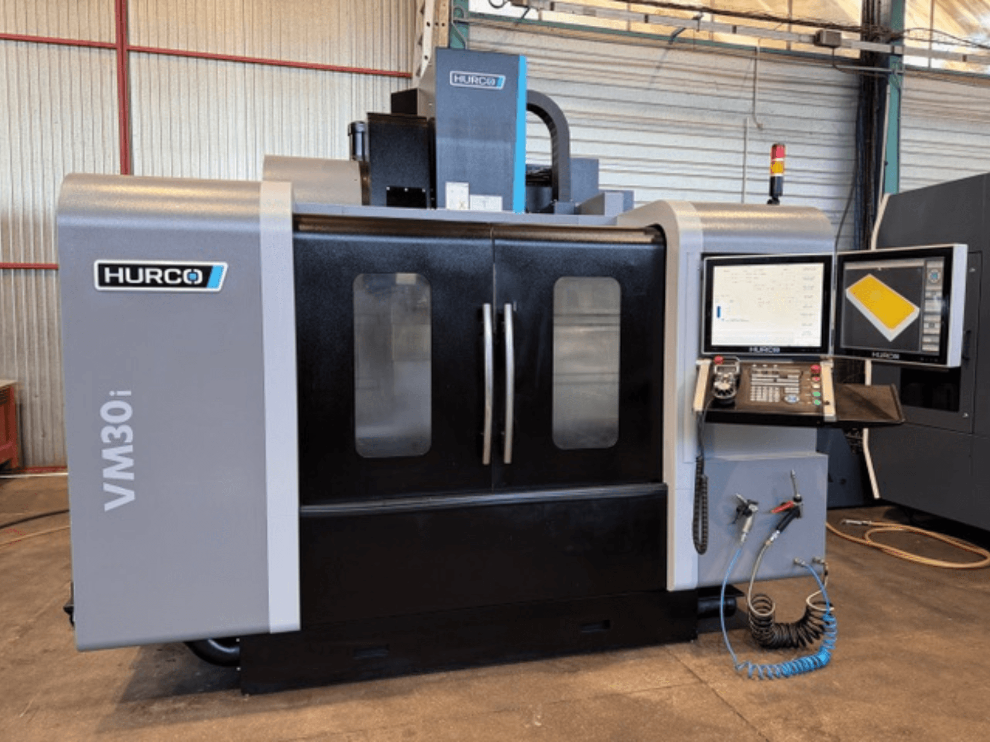 Hurco VM30i Vertical Machining Centre, front view showcasing control panel, display screens, and machine doors.