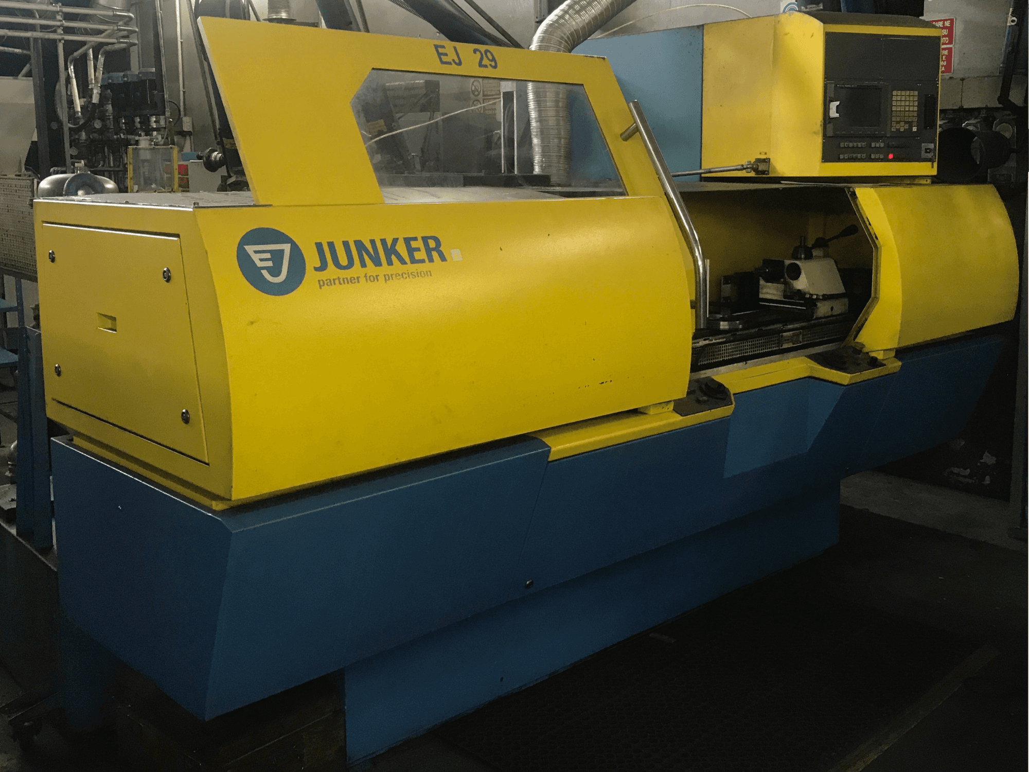 JUNKER EJ 29 grinding machine, front view, features yellow and blue casing, control panel, and visible internal components.