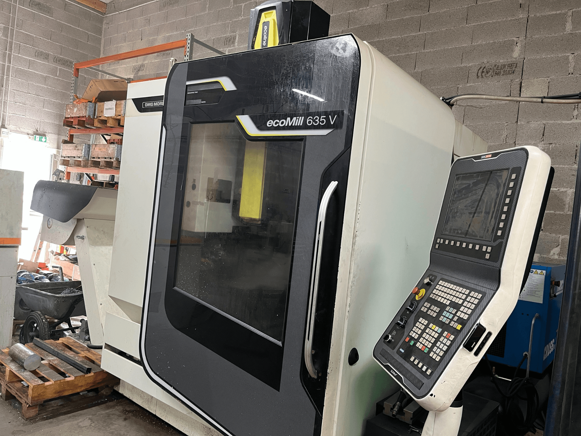 EcoMill 635 V CNC milling machine, front view, features control panel with buttons, located in industrial workspace.