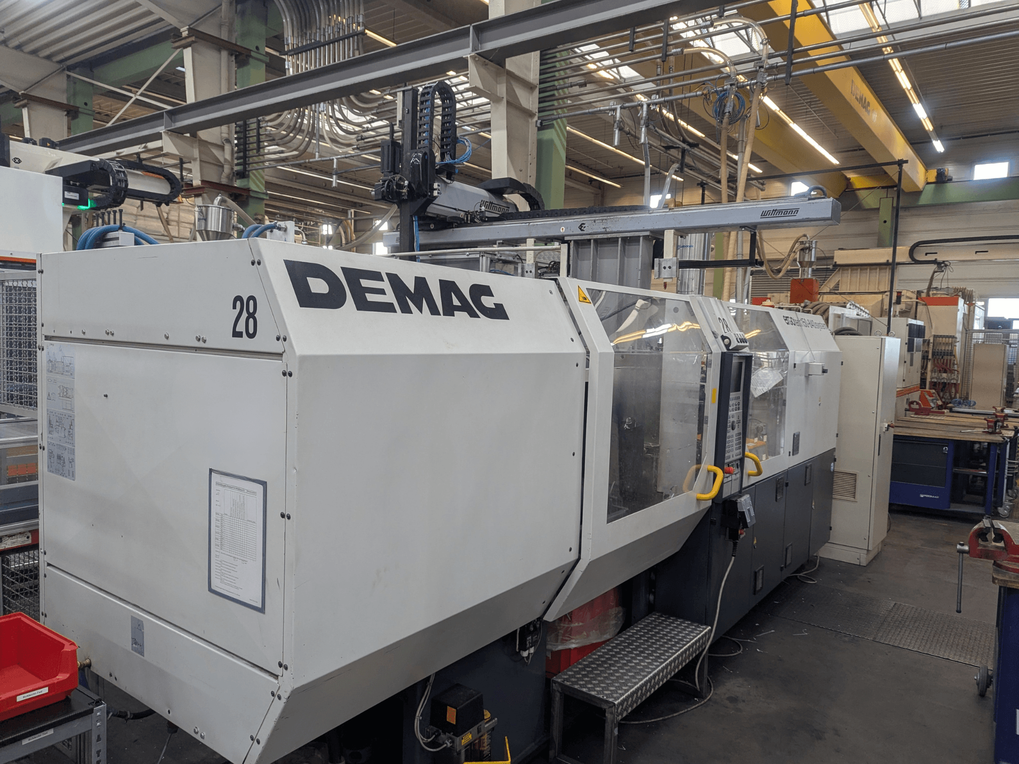 Front view of a DEMAG ERGOTECH 1500-840 hydraulic injection moulding machine, showcasing operational controls and safety features.