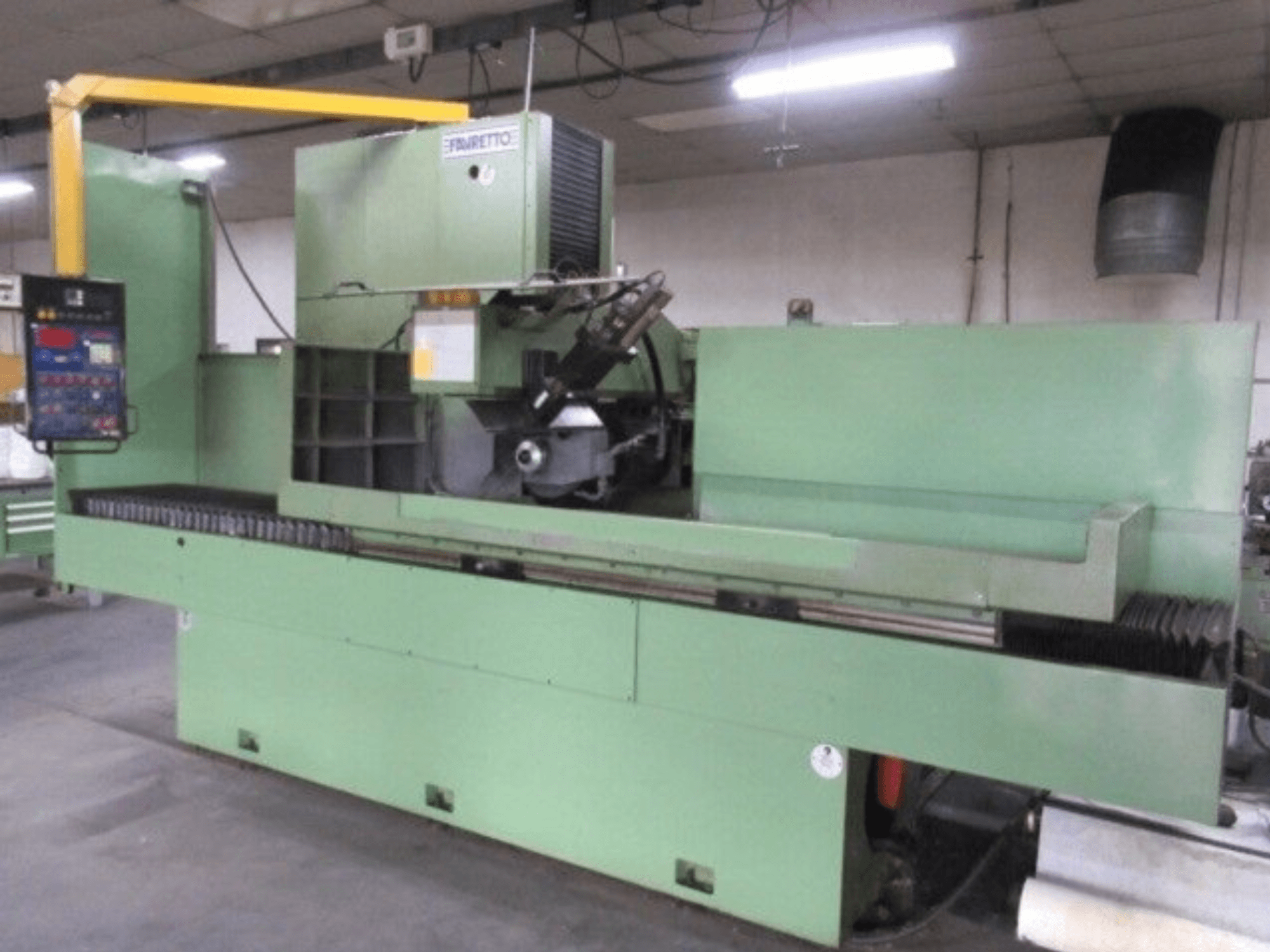 Green industrial milling machine by Brandt, side view, with digital control panel and rotating blade for precision cutting.