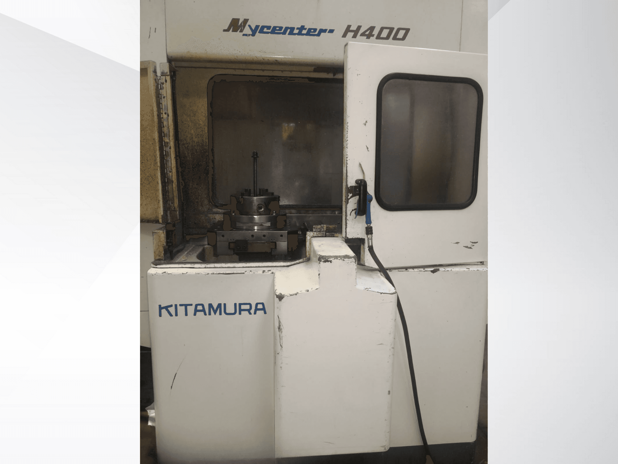 Kitamura Mycenter H400 CNC machine, front view, with visible work area and control panel, showing signs of use.